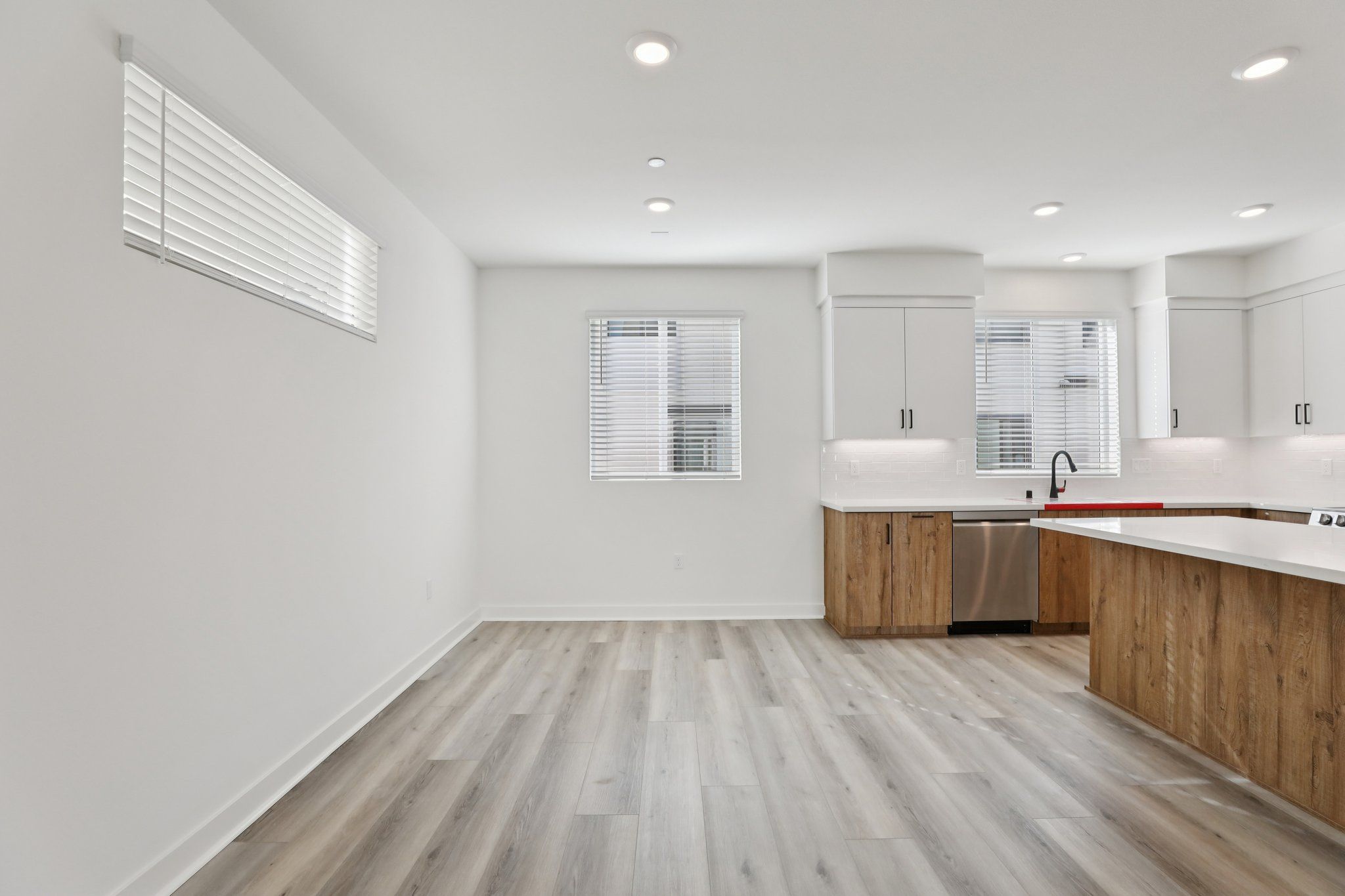 Dining area with upgraded flooring and natural light