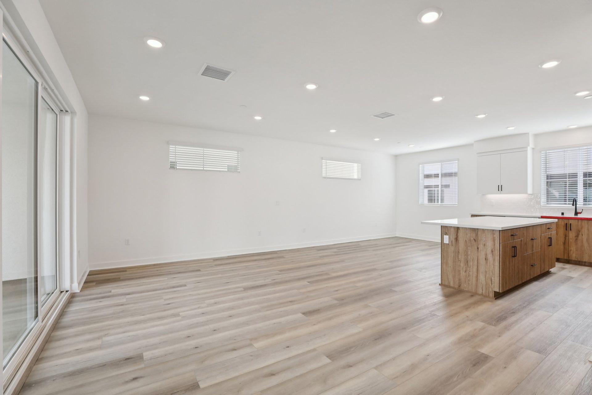 Spacious great room with upgraded flooring, window treatments, and stunning deck