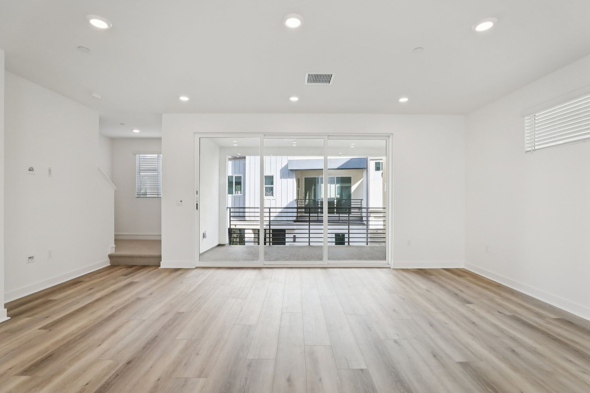 Stunning great room with upgraded flooring and upgraded stacking doors leading to deck for added living space