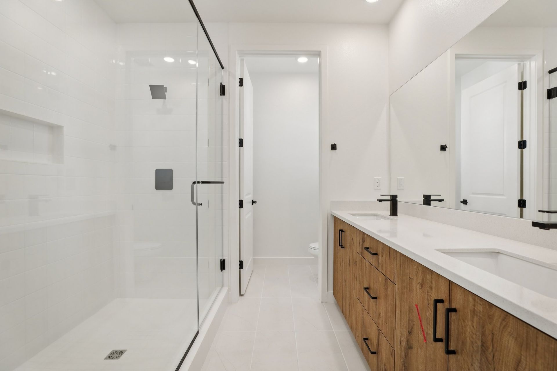 Primary bath with tiled shower and upgraded tile flooring