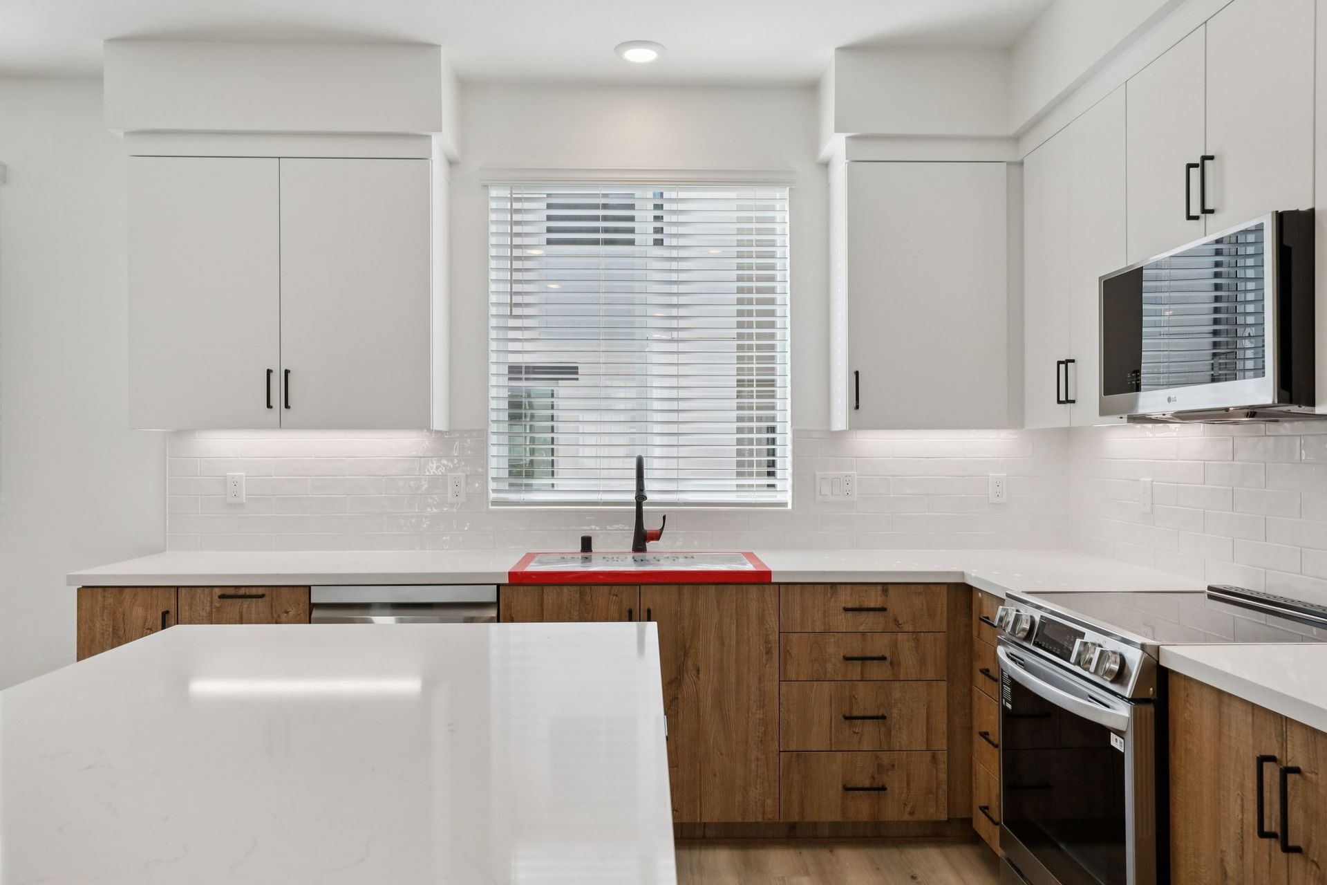 Gourmet kitchen with upgraded two-tone cabinets and designer backsplash