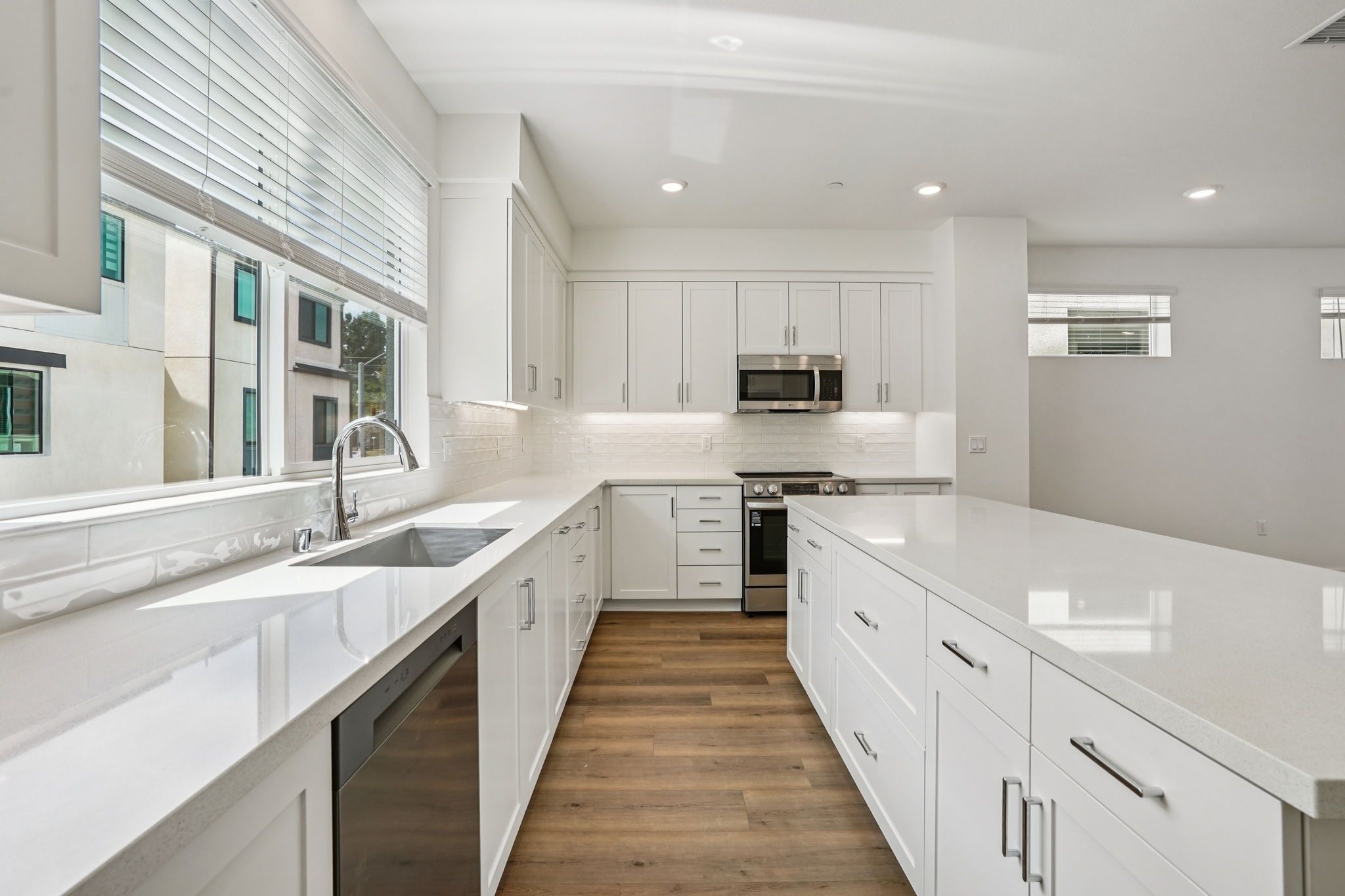 Open-concept kitchen with quartz counters and large island