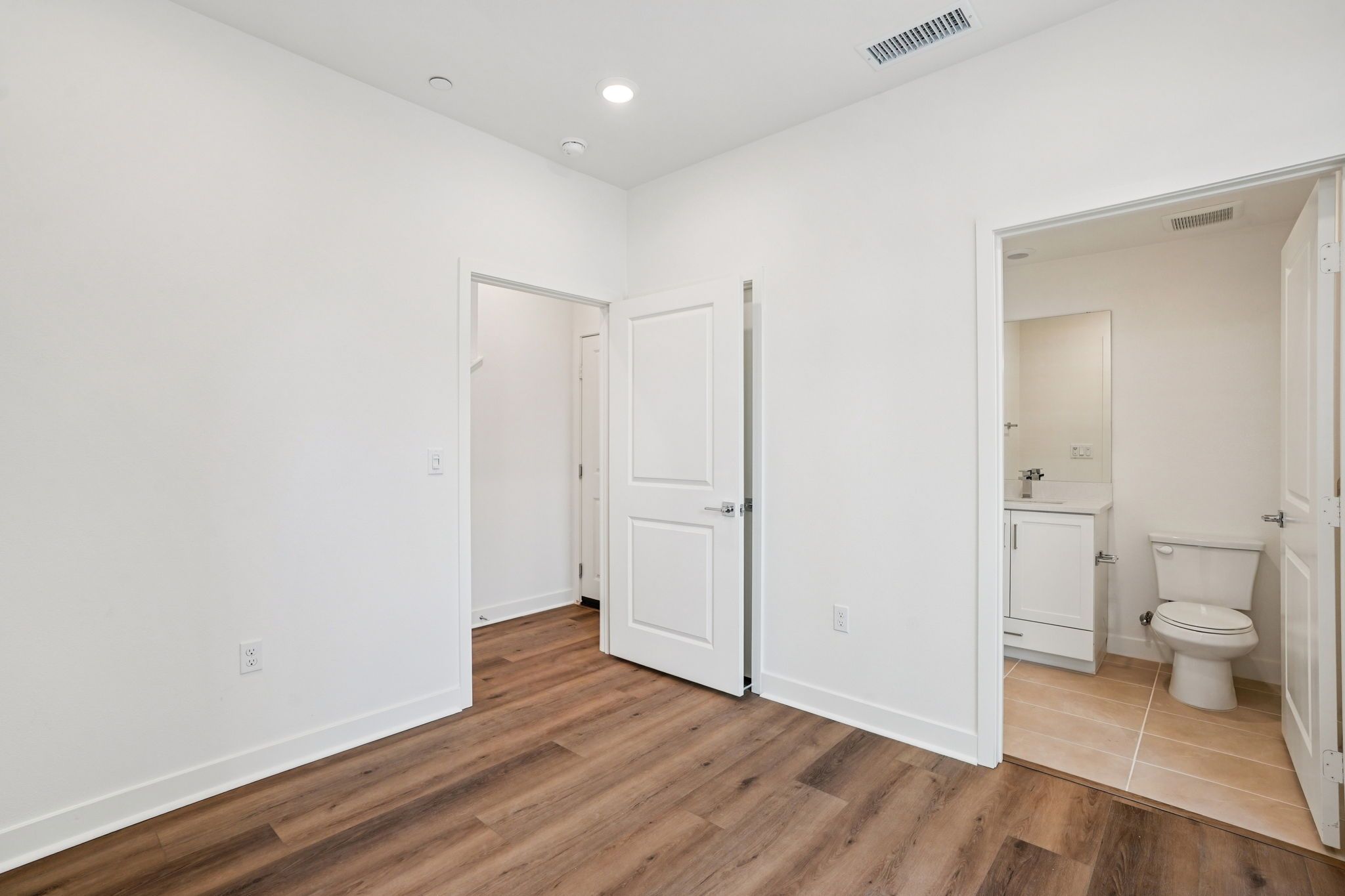 First-floor junior primary suite with an ensuite and walk-in closet