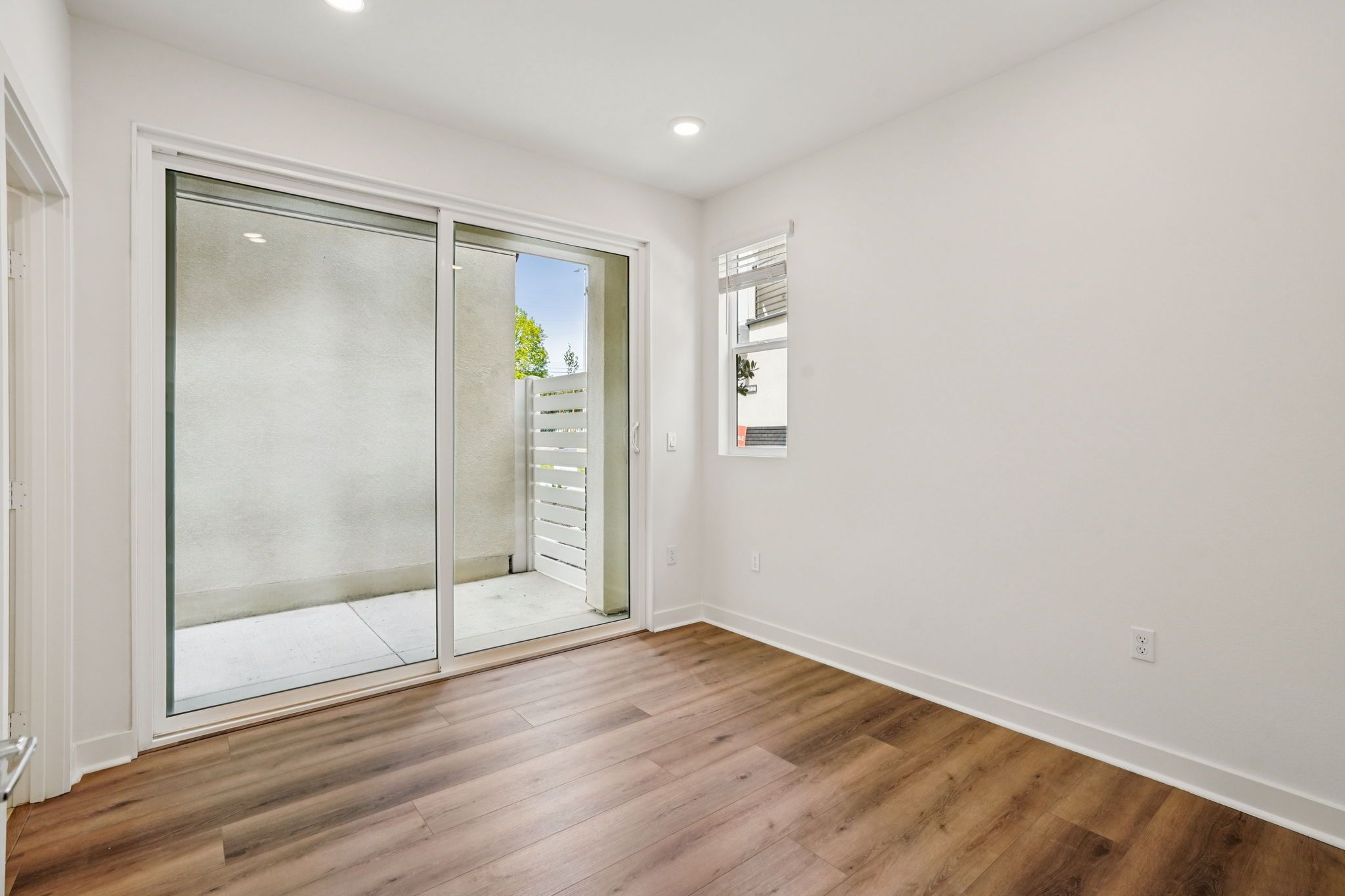 Bright den with sliding doors that open to a private outdoor patio