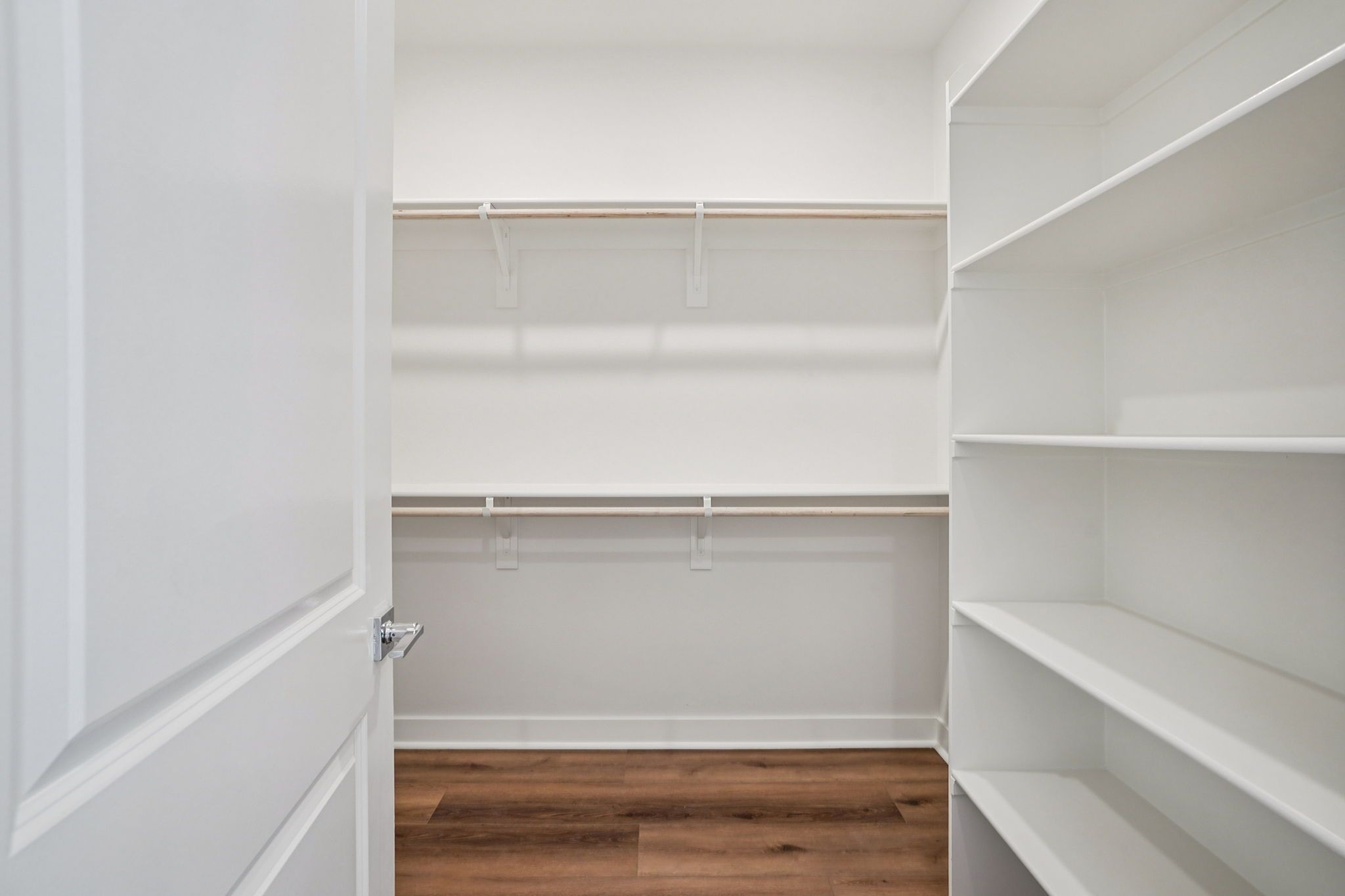 Large closet with ample shelving and hanging space.