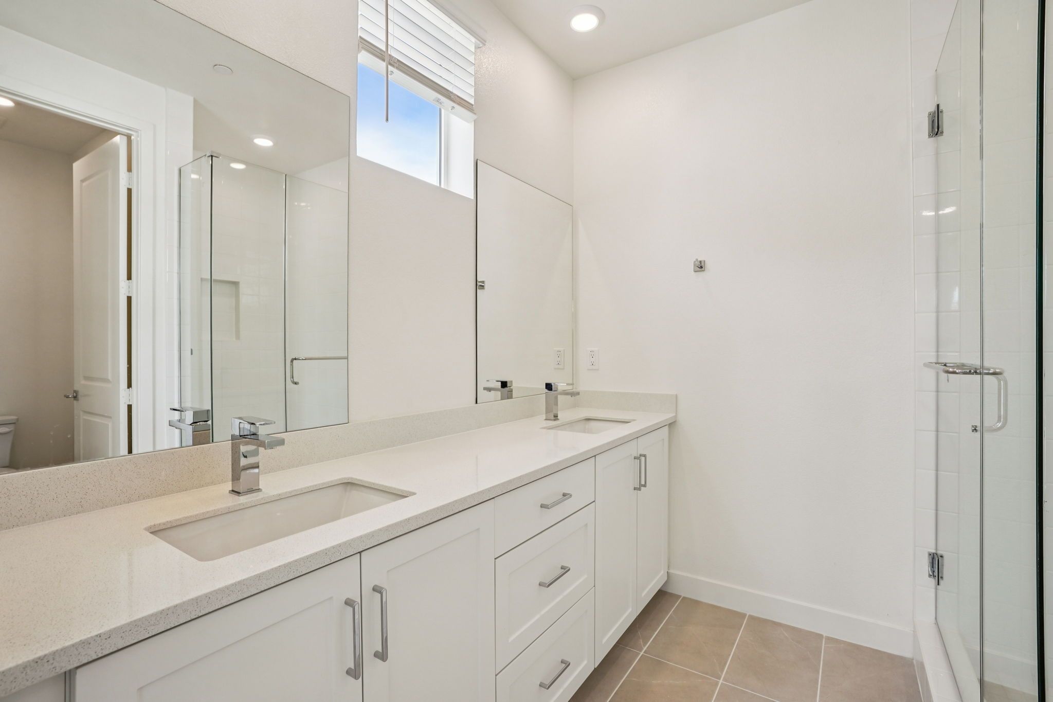 Primary bathroom featuring a double vanity and shower