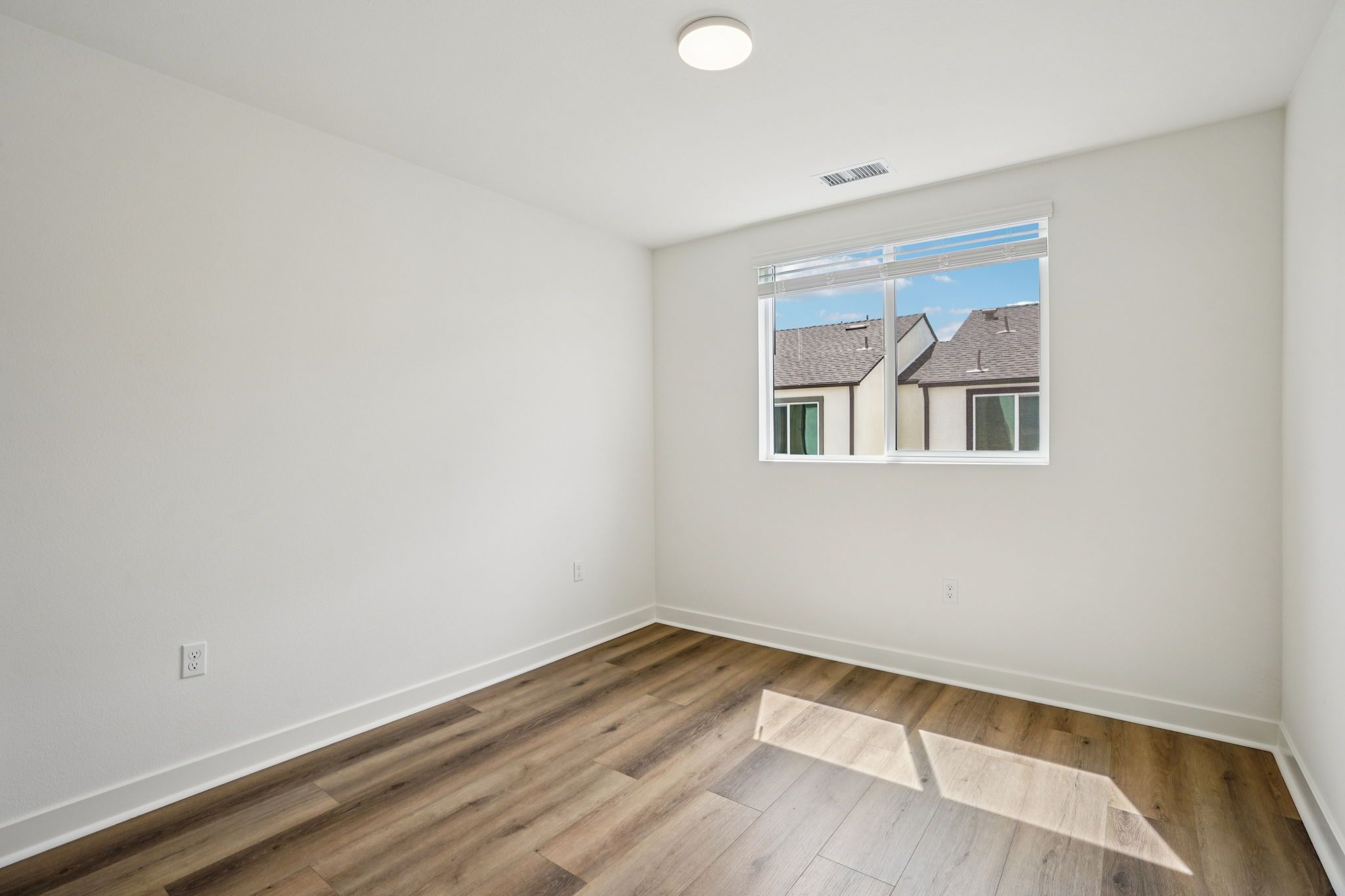 Bright secondary bedroom 2 featuring a large window and a comfortable layout