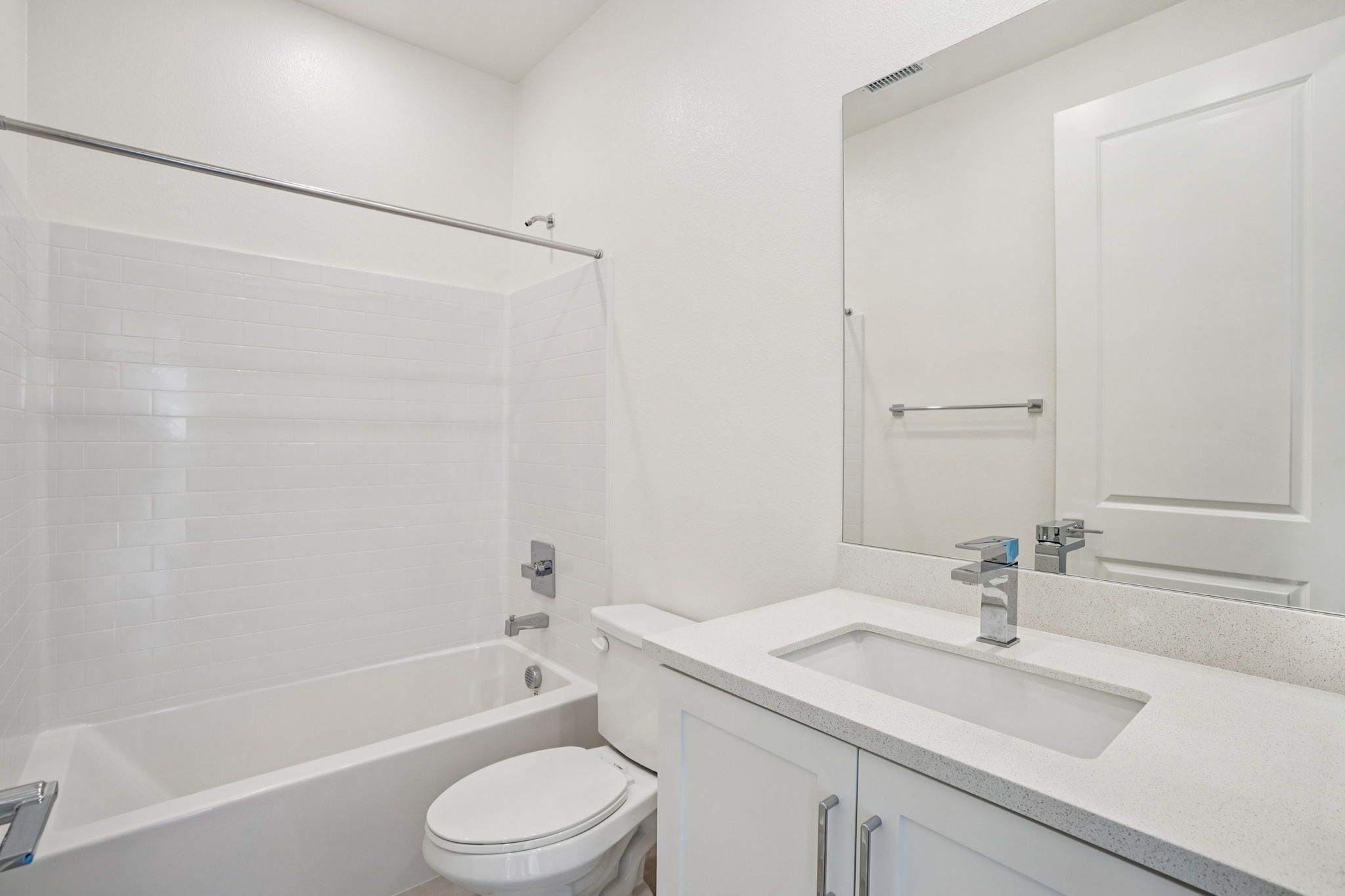 Bright secondary bathroom featuring a single sink and shower