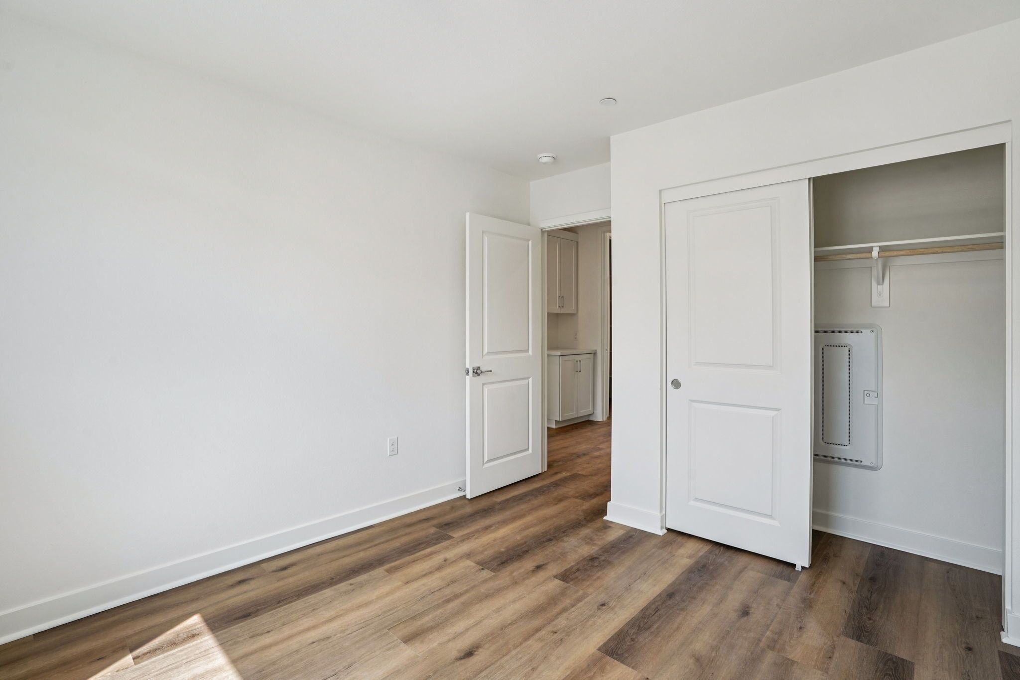 Secondary bedroom 2 with upgraded flooring and closet