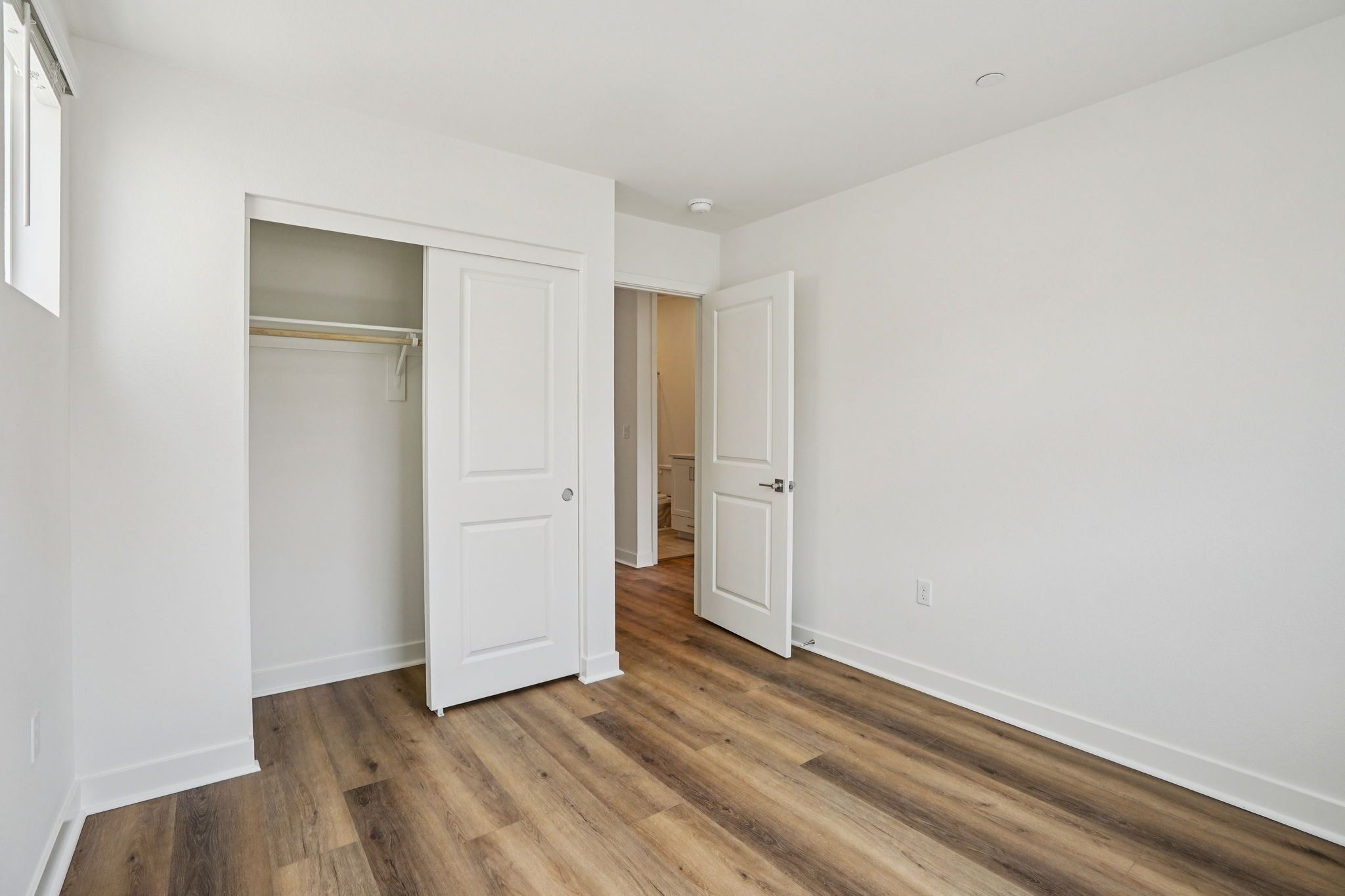 Secondary bedroom 3 with upgraded flooring and closet