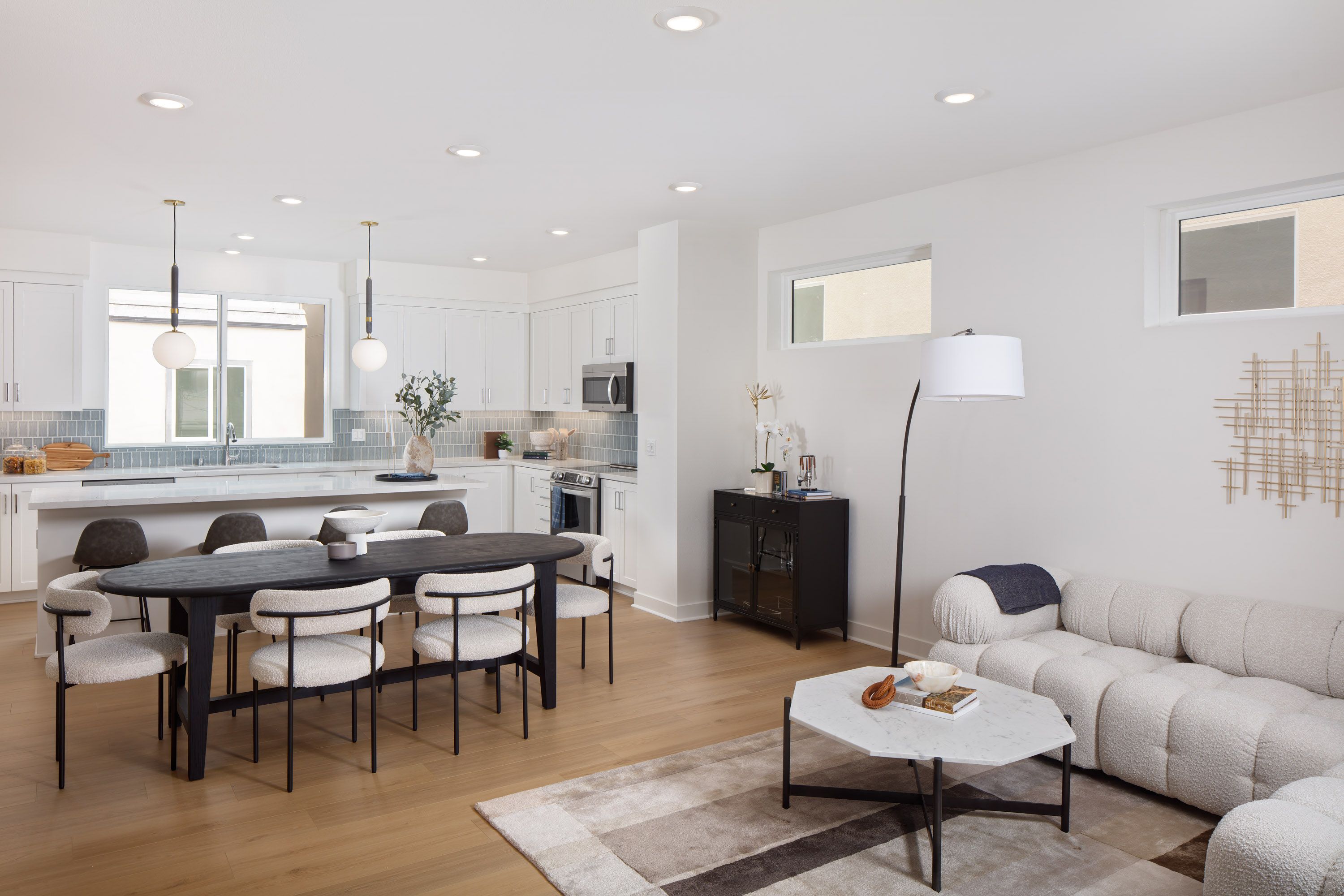 Model home great room featuring an open layout for kitchen, dining, and living.