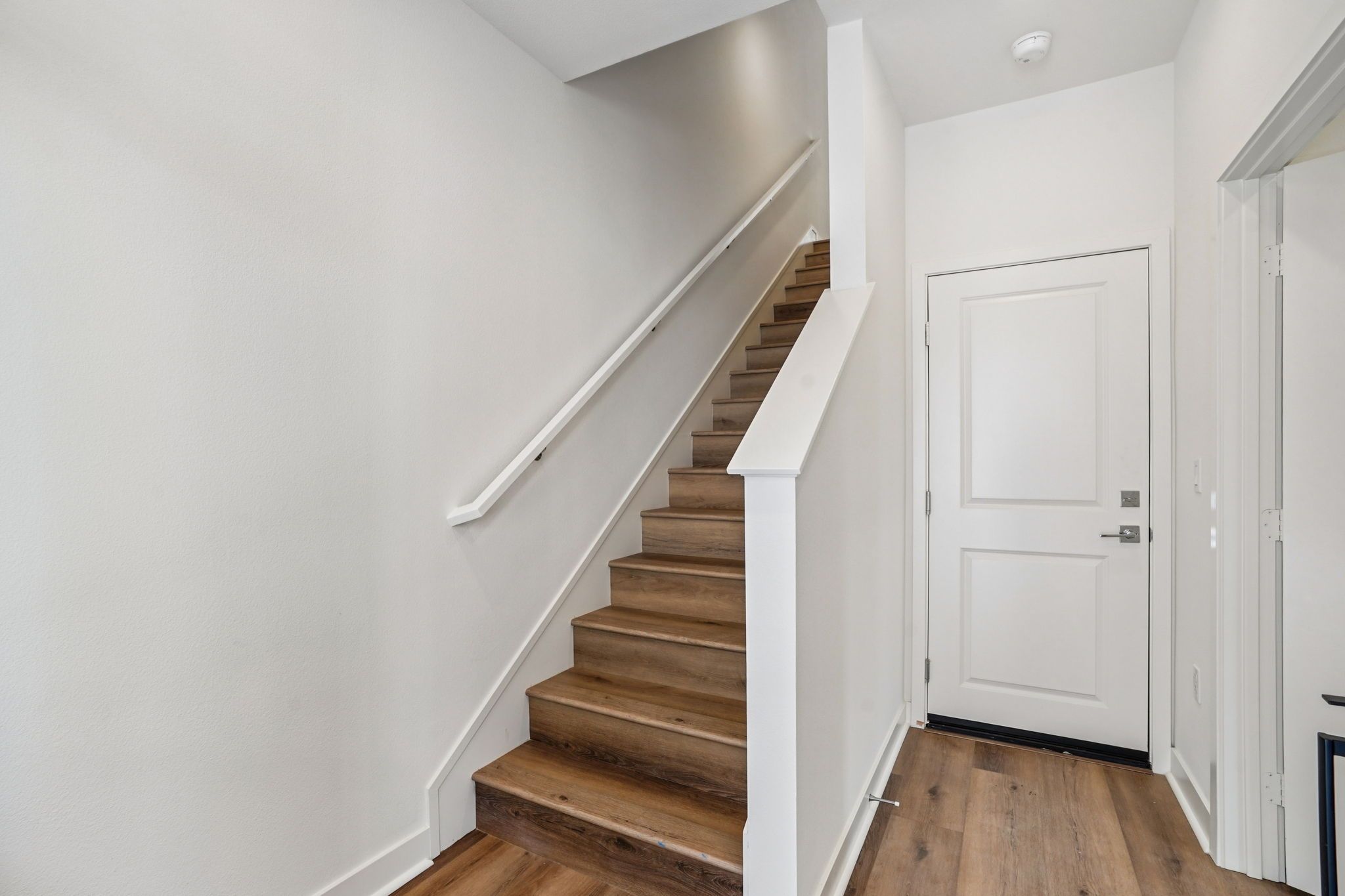 Entry stair case with upgraded flooring throughout