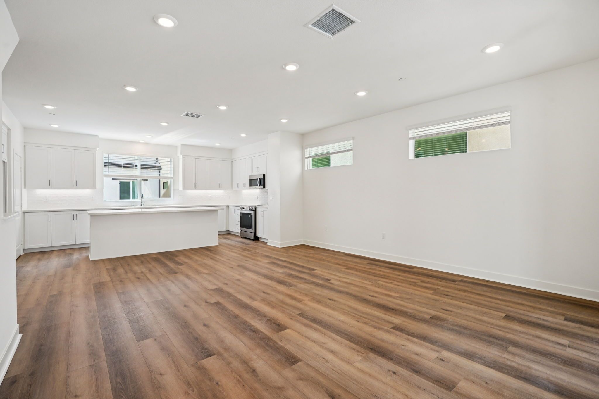 Large open concept great room with upgraded flooring
