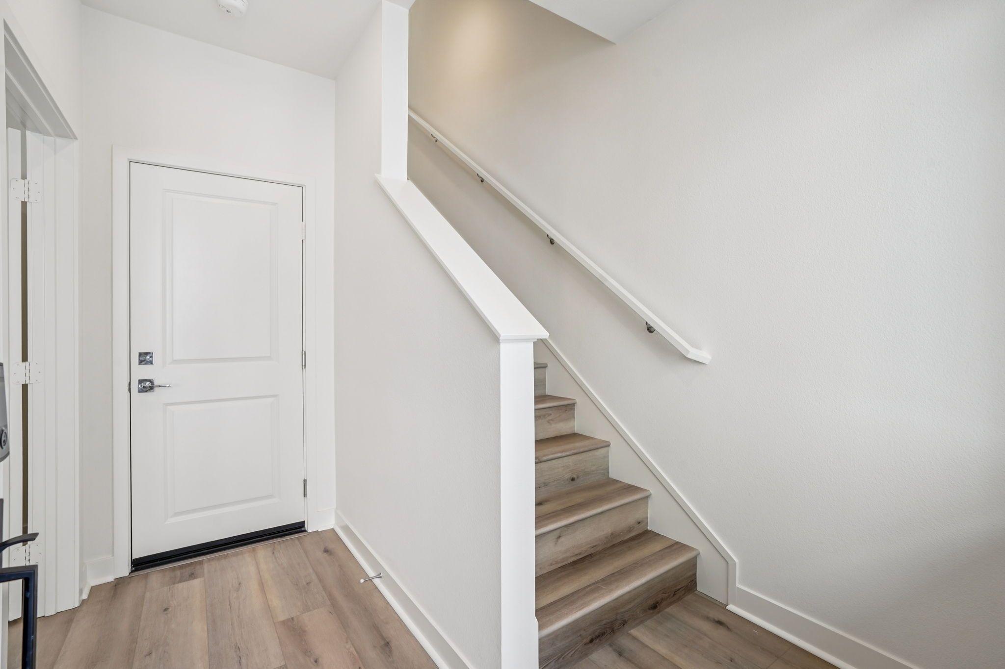 Entry stair case with upgraded flooring throughout 
