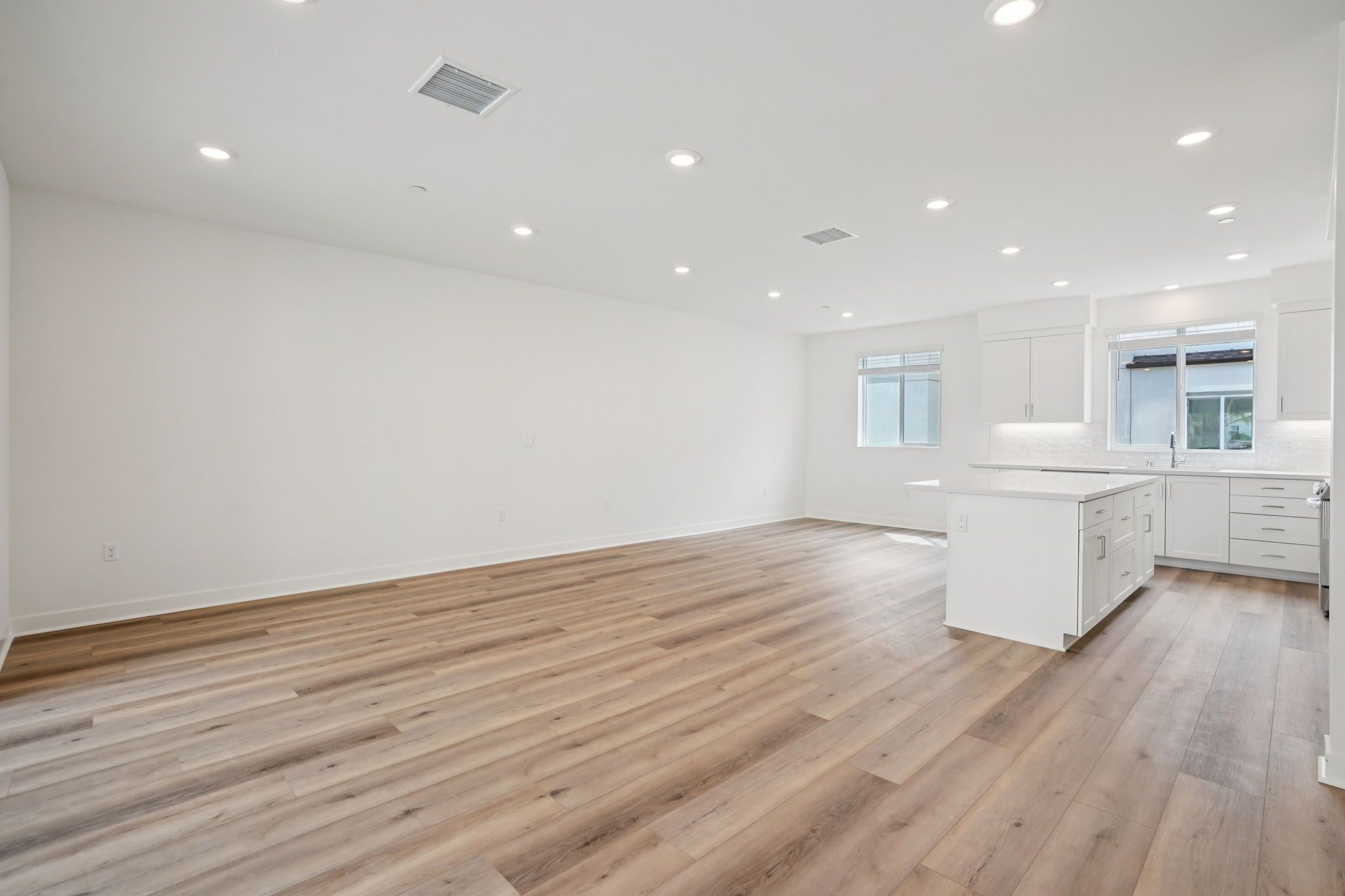 Large open concept great room with upgraded flooring