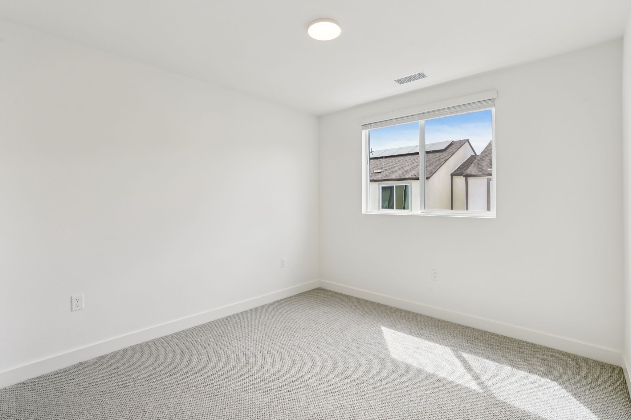 Bright secondary bedroom 2 featuring a large window and a comfortable layout