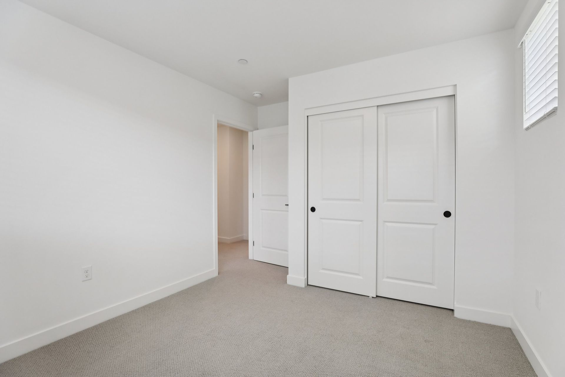 Secondary bedroom 3 with upgraded flooring and closet