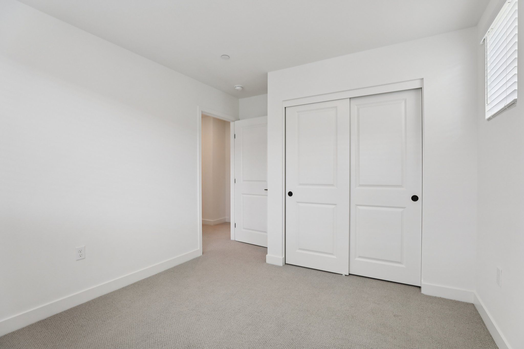 Secondary bedroom 3 with upgraded flooring and closet