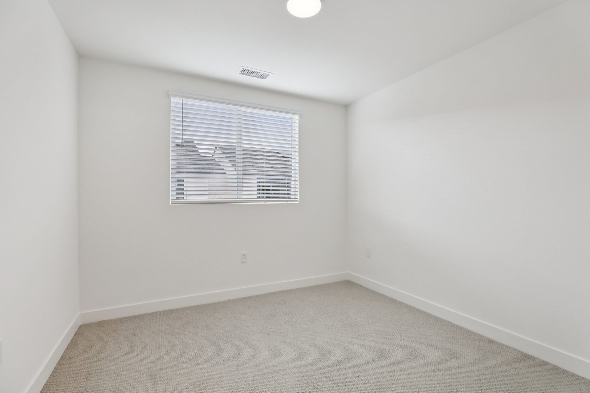Bright secondary bedroom 2 featuring a large window and a comfortable layout