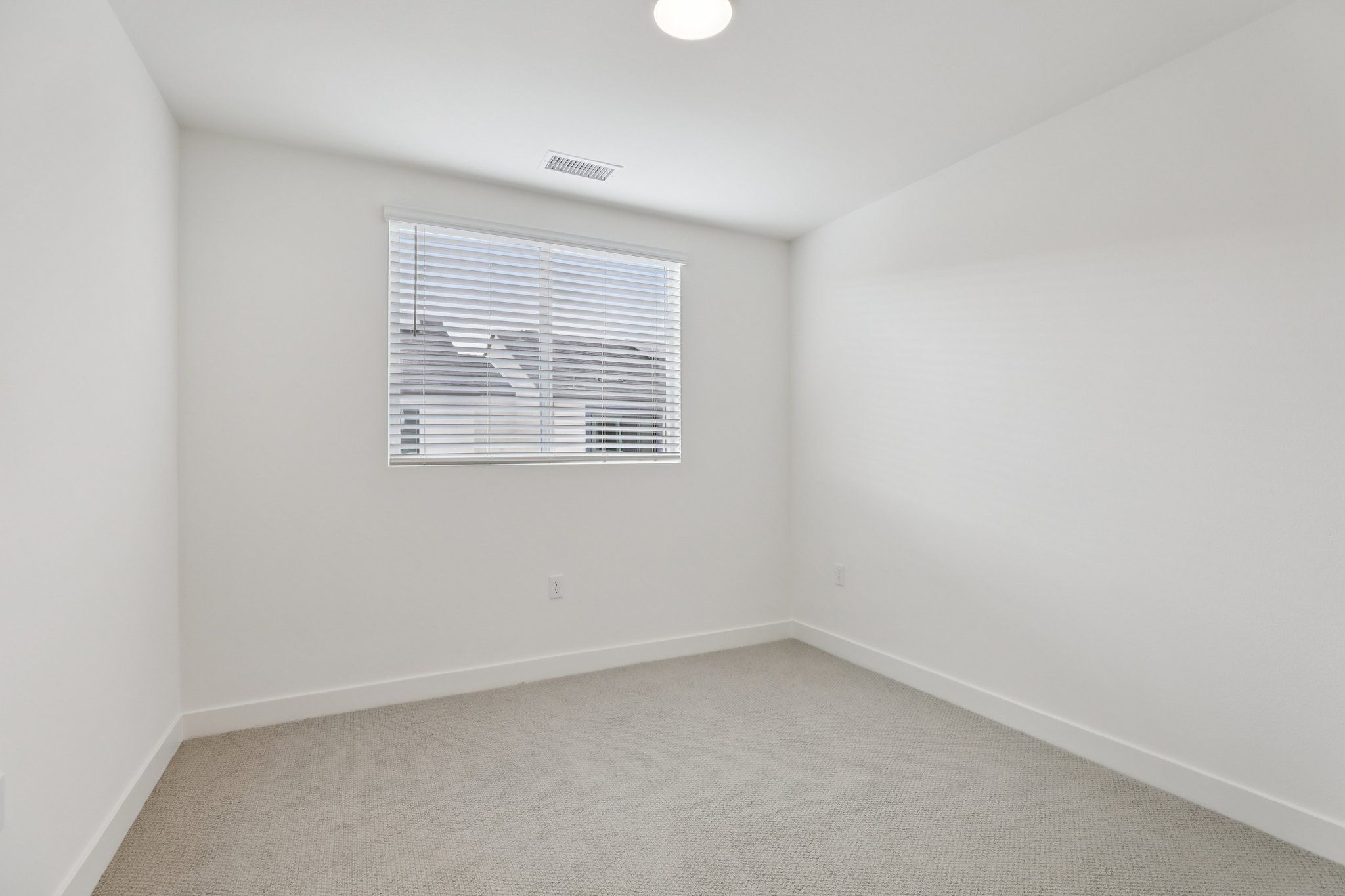 Bright secondary bedroom 2 featuring a large window and a comfortable layout