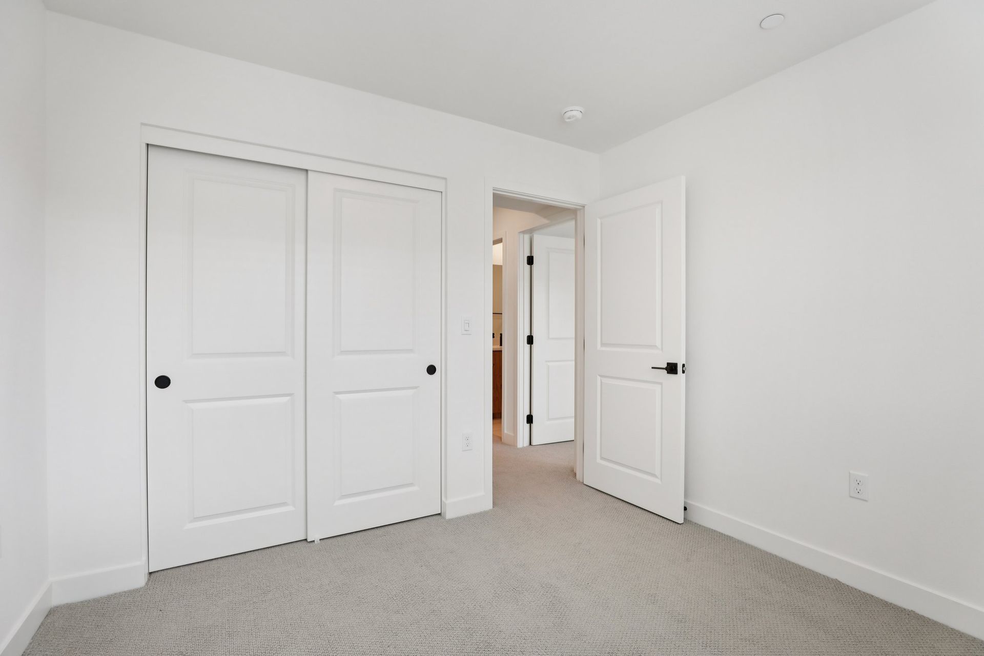 Secondary bedroom 2 with upgraded flooring and closet