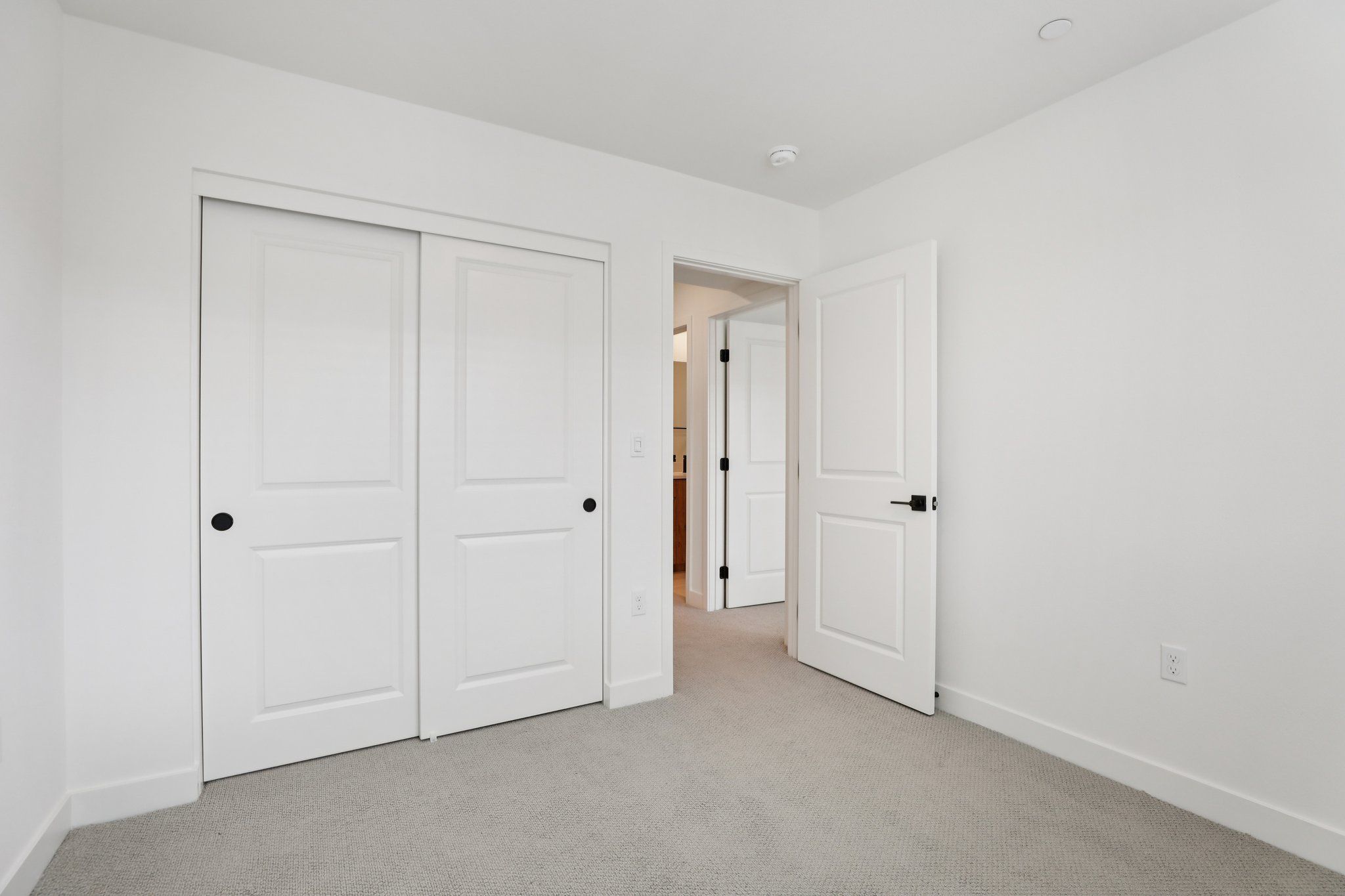 Secondary bedroom 2 with upgraded flooring and closet
