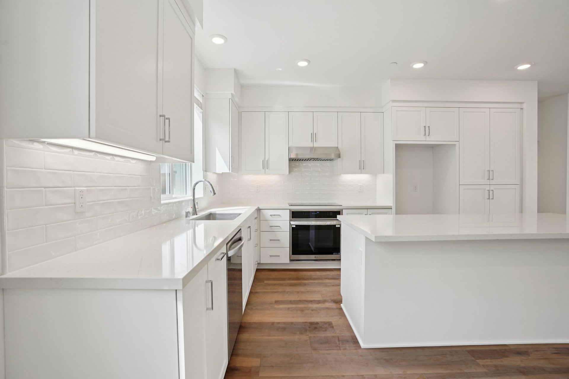 Open-concept kitchen with quartz counters and large island