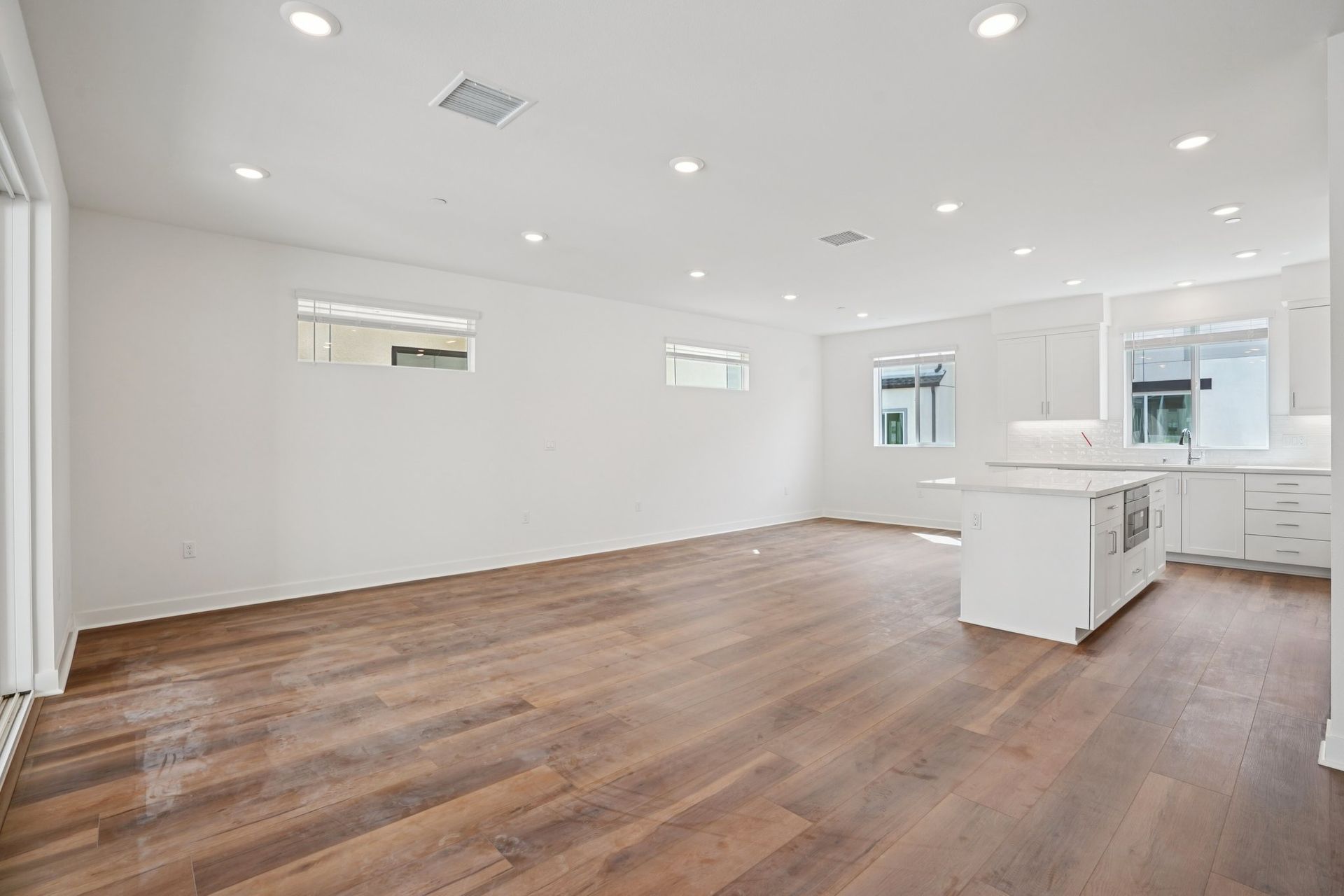 Large open concept great room with upgraded flooring