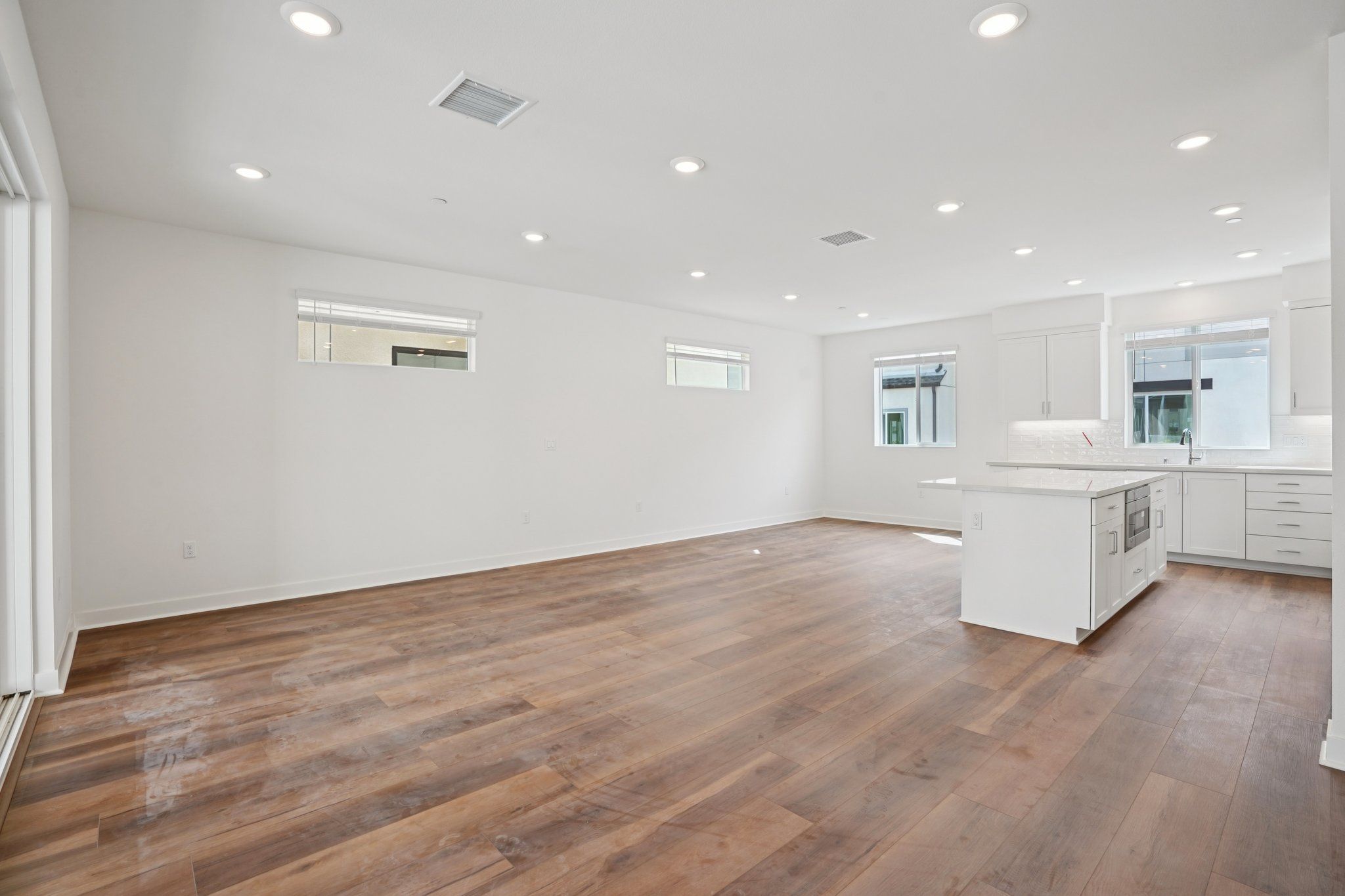 Large open concept great room with upgraded flooring