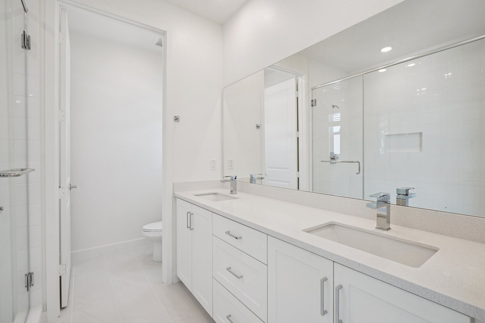 Primary bathroom featuring a double vanity and shower