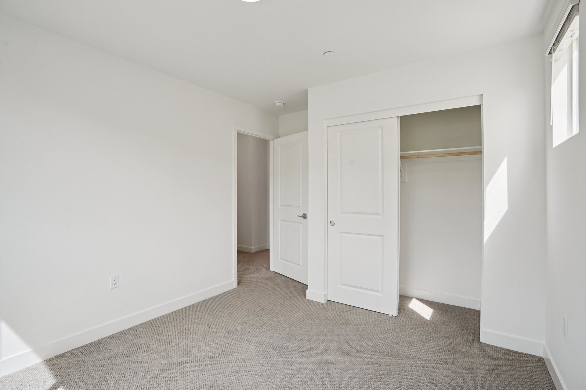 Secondary bedroom 2 with upgraded flooring and closet