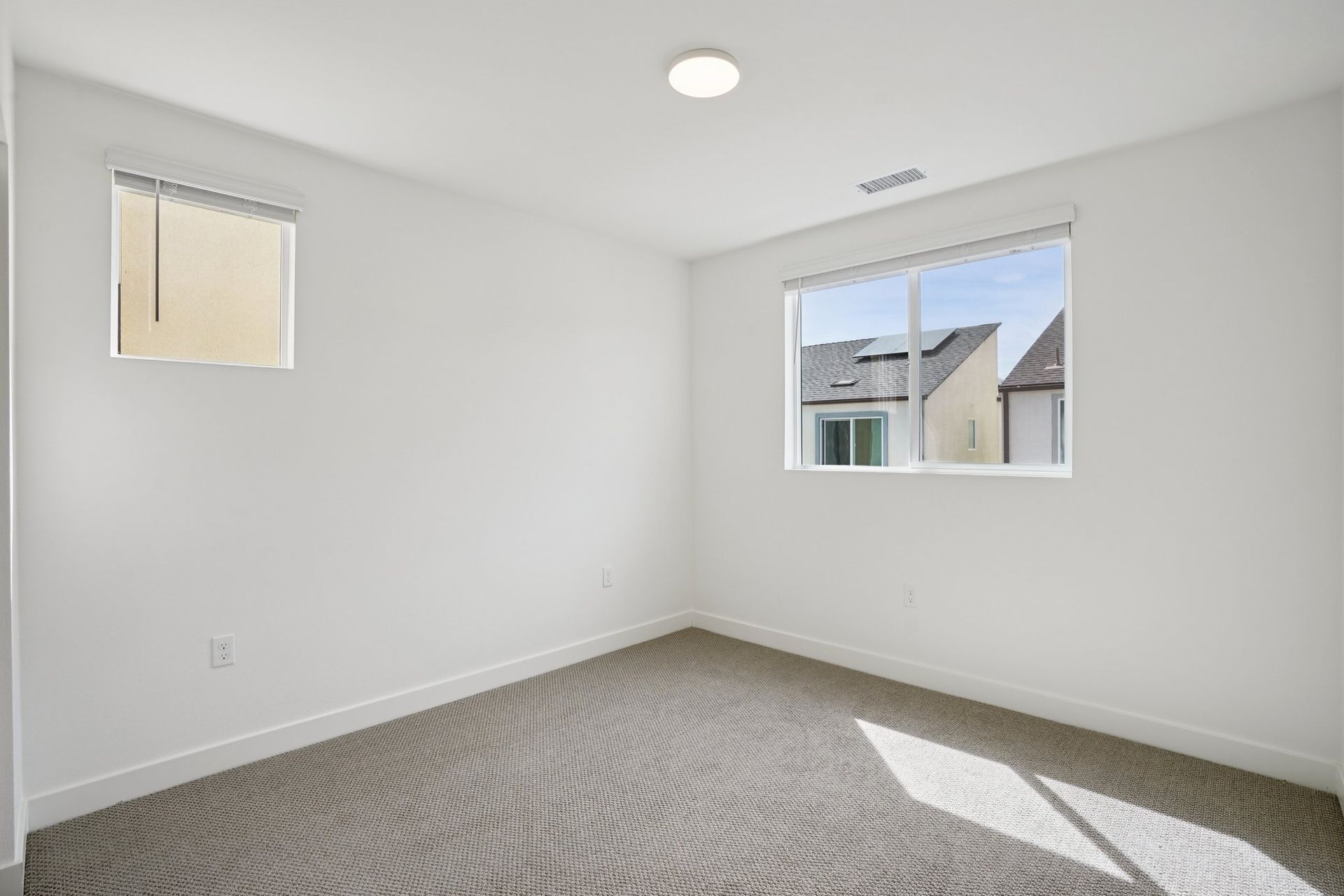 Bright secondary bedroom 2 featuring a large window and a comfortable layout