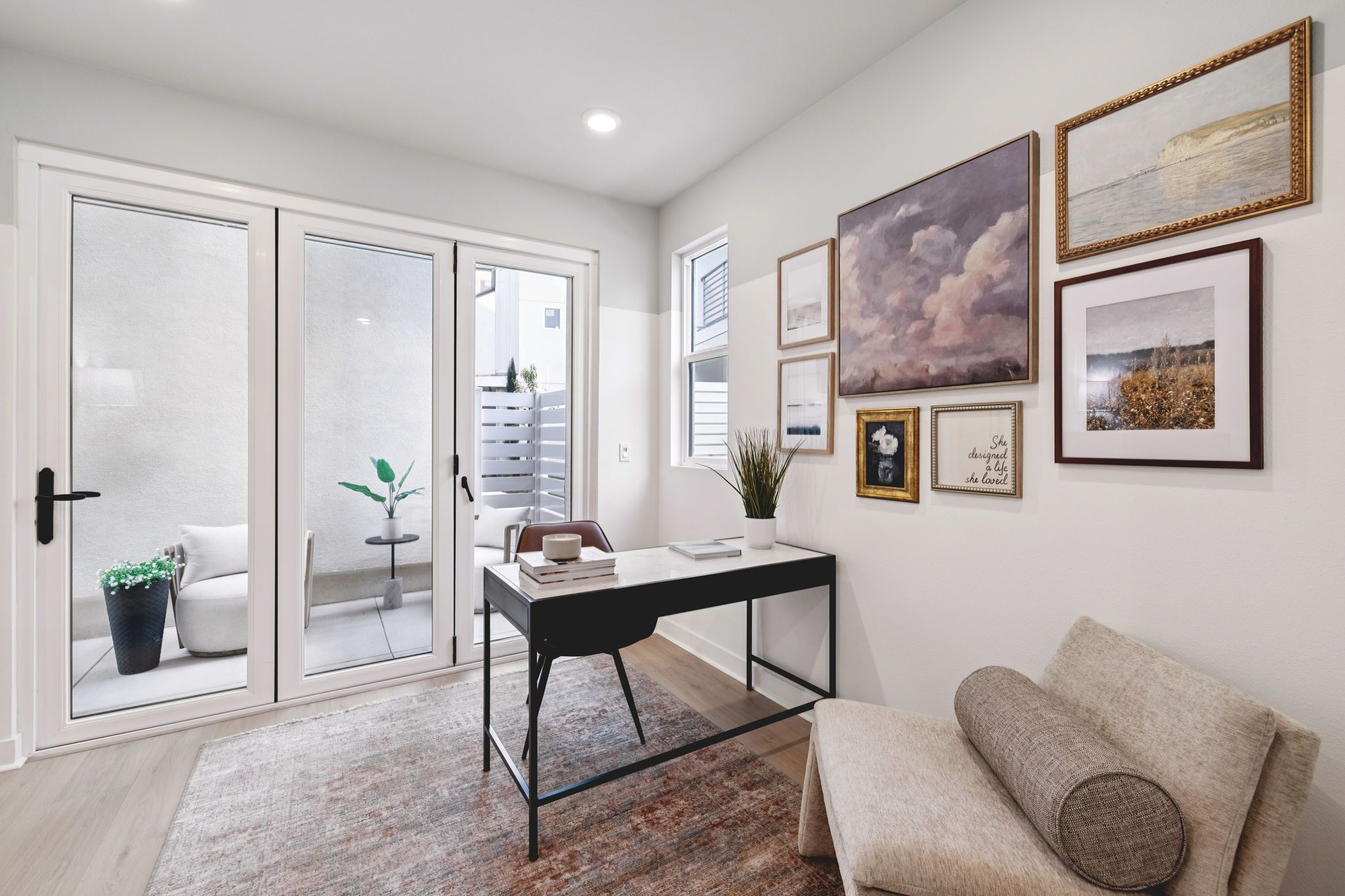 Model home bright den with sliding doors that open to a private outdoor patio