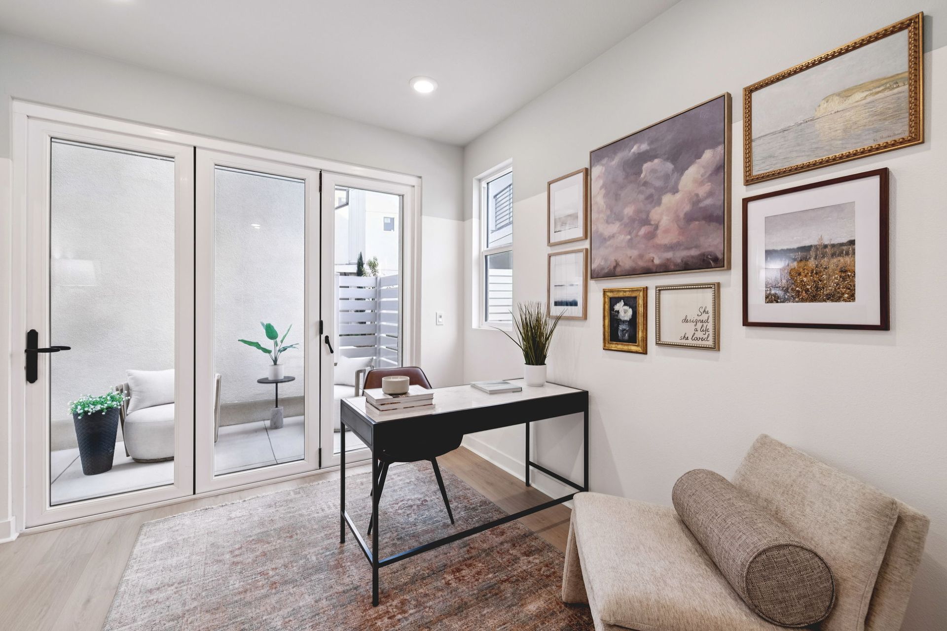 Model home bright den with sliding doors that open to a private outdoor patio