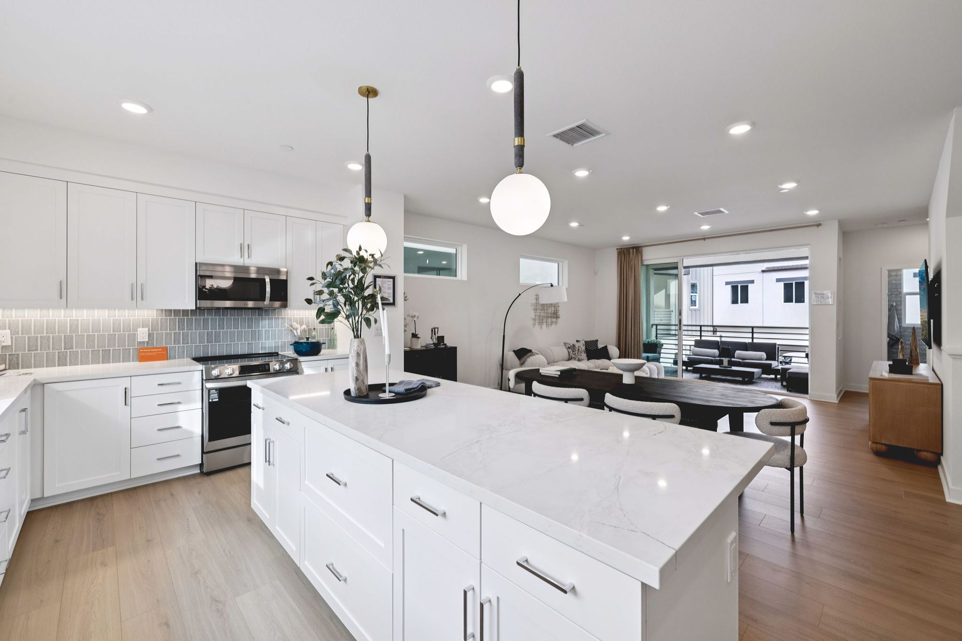 Model home great room featuring an open layout for kitchen, dining, and living.