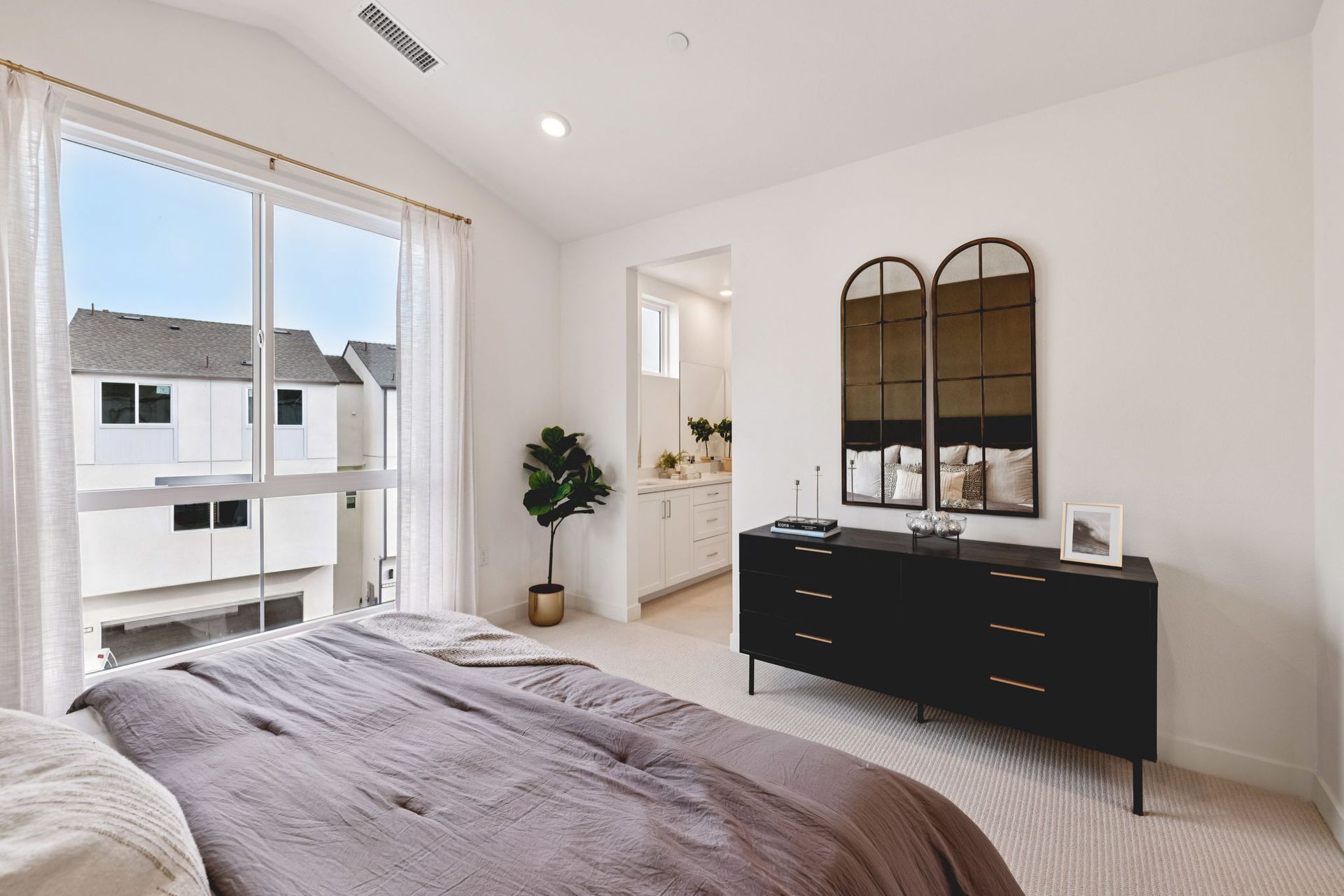 Model home large primary bedroom with ensuite Bathroom and vaulted ceilings