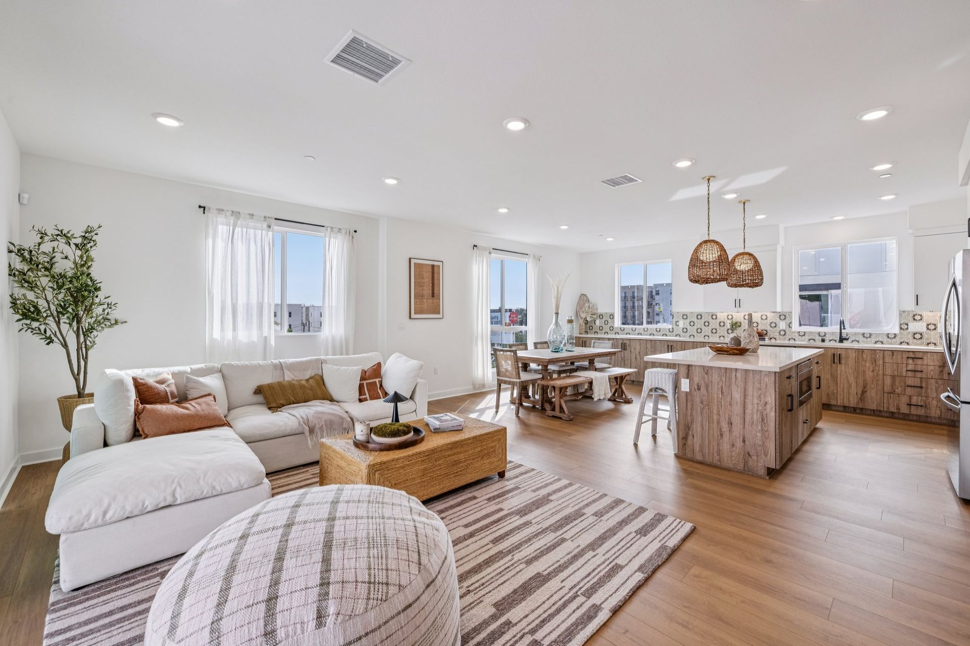 Model home great room featuring an open layout for kitchen, dining, and living.
