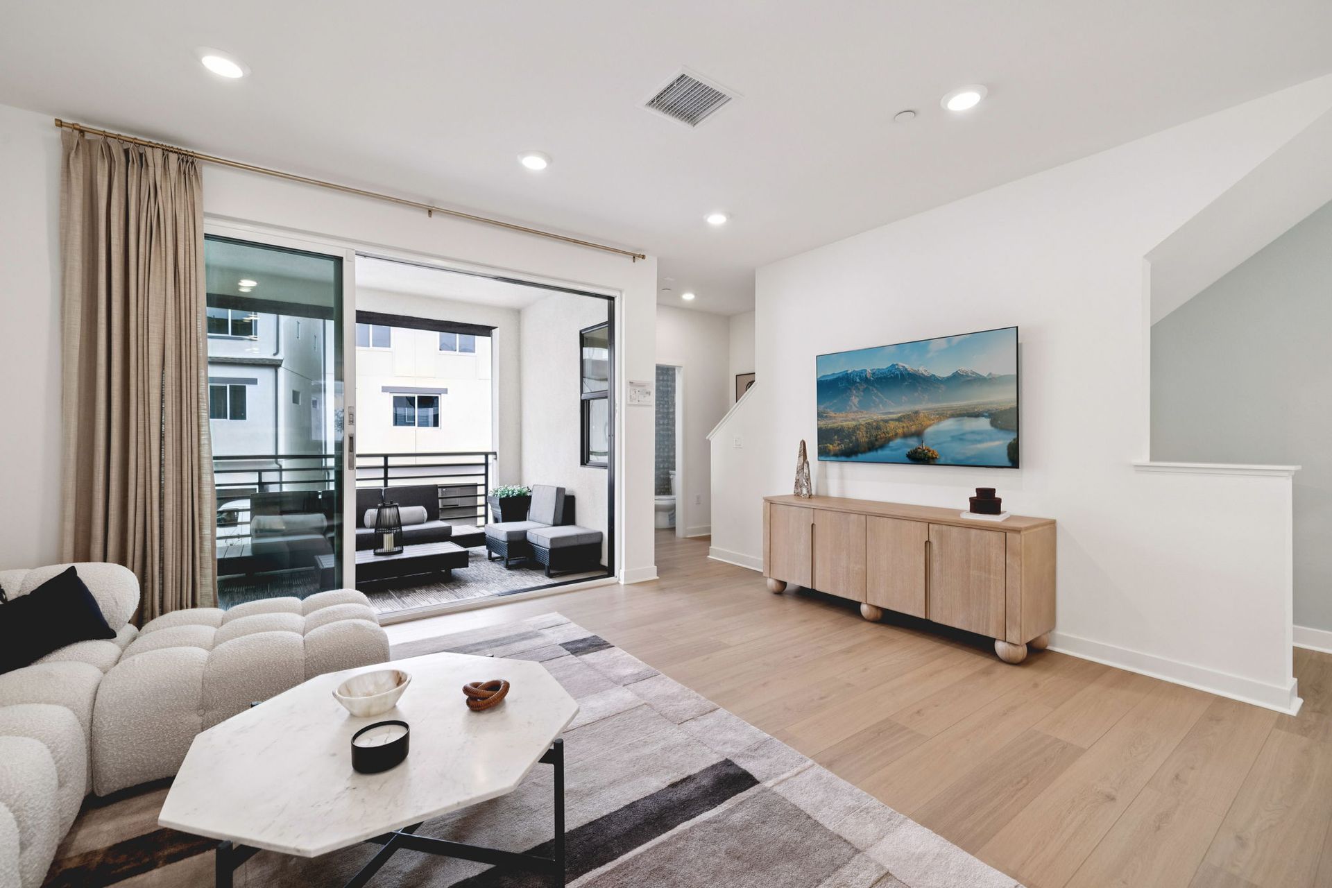 Model home bright living area adjacent to outdoor deck