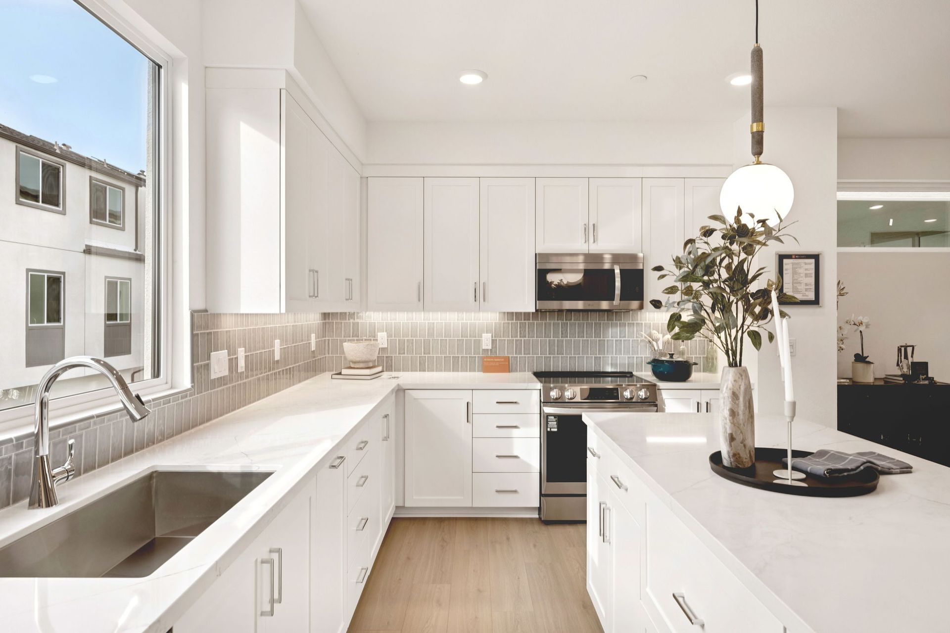 Model home kitchen featuring a quartz-fitted island and countertops.
