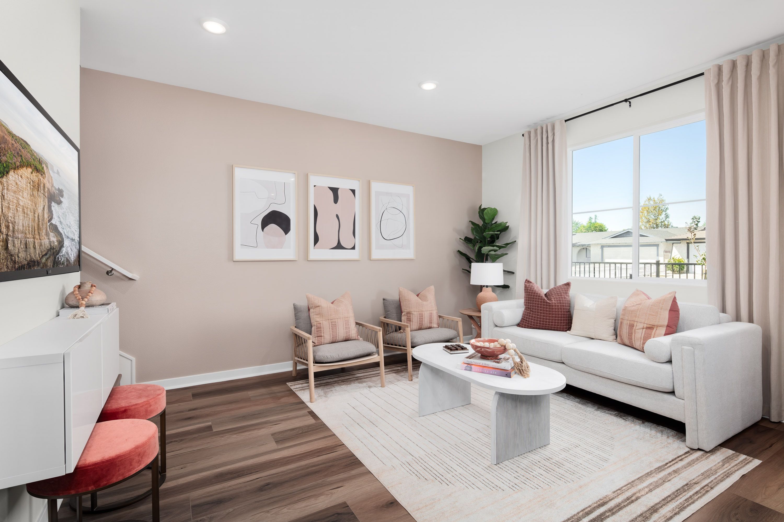 Plan 1 model home open-concept living area with plenty of natural light from the window