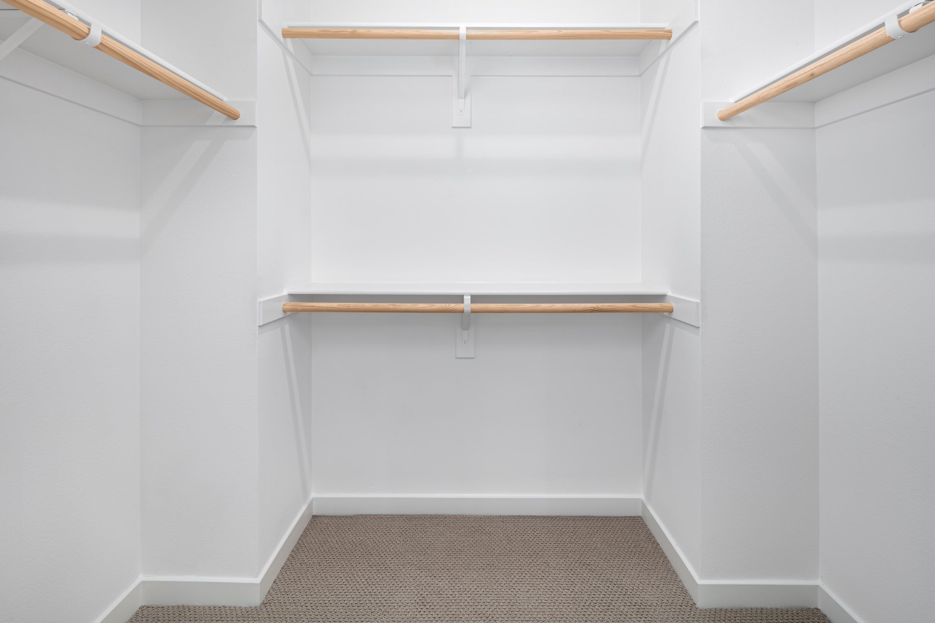 Plan 1 model home walk-in closet connected to the primary bathroom.