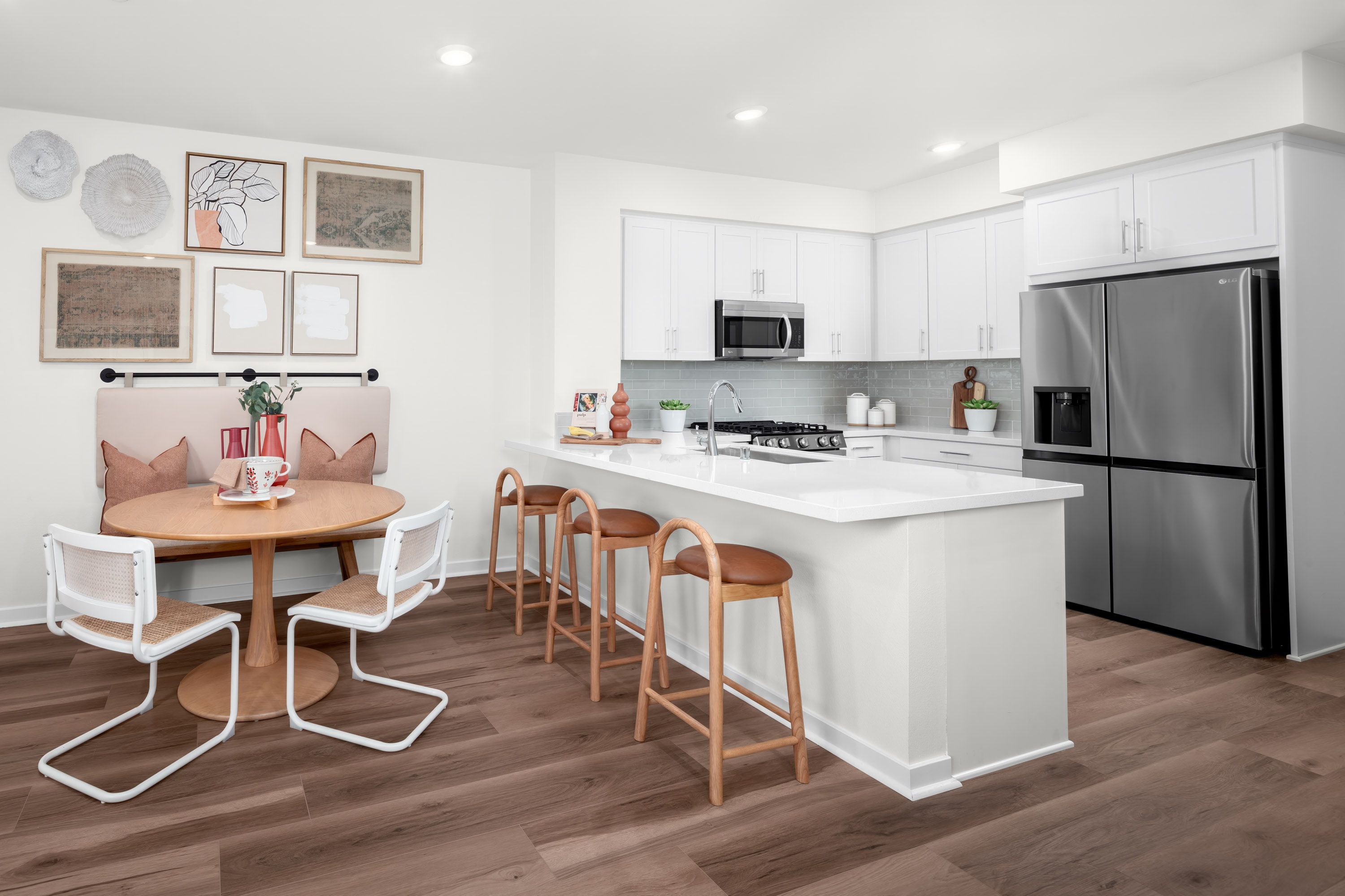 Plan 1 model home dining area conveniently located beside the kitchen peninsula