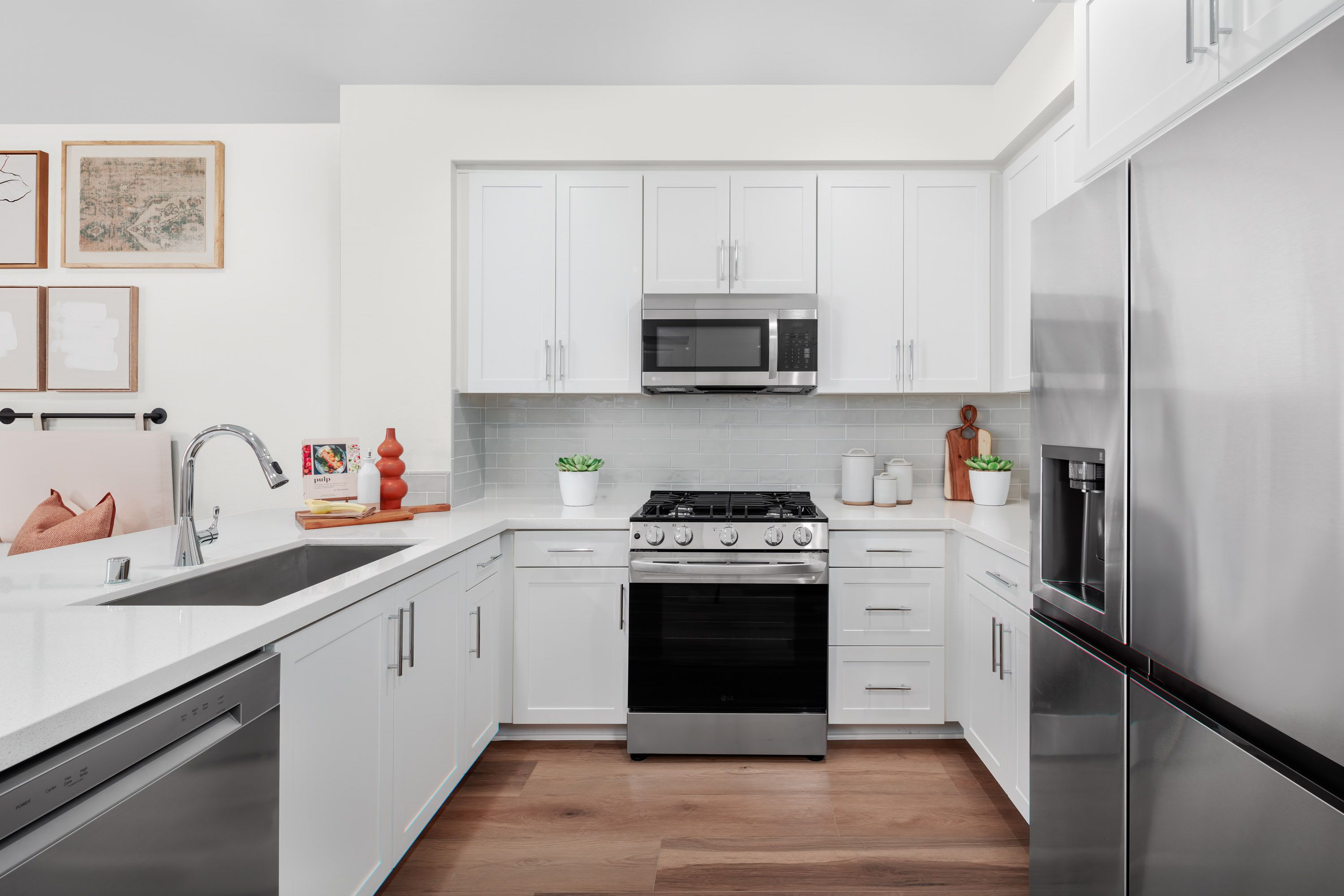 Plan 1 model home kitchen equipped with select stainless steel appliances