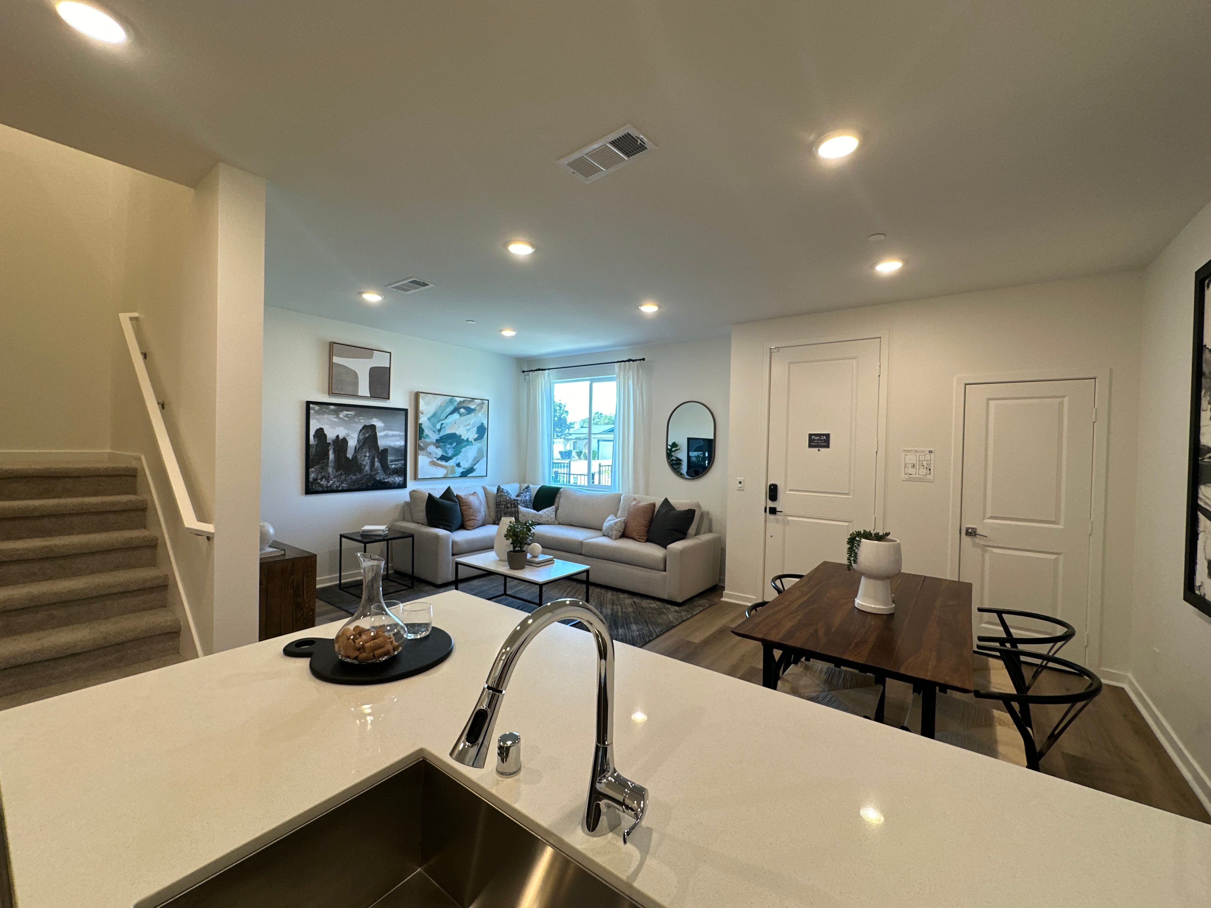 Model home connected living, dining, and kitchen area