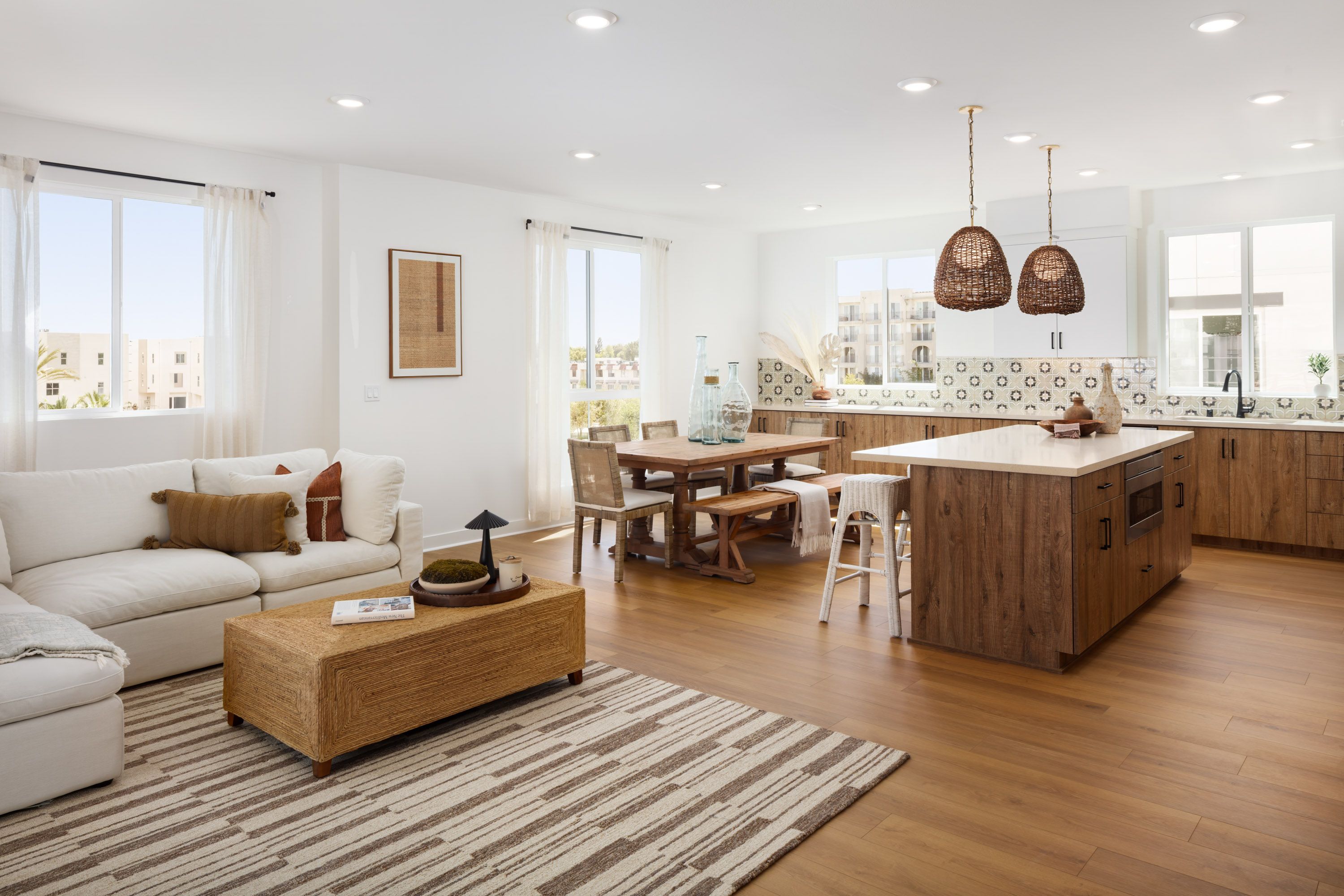 Model home great room featuring an open layout for kitchen, dining, and living.