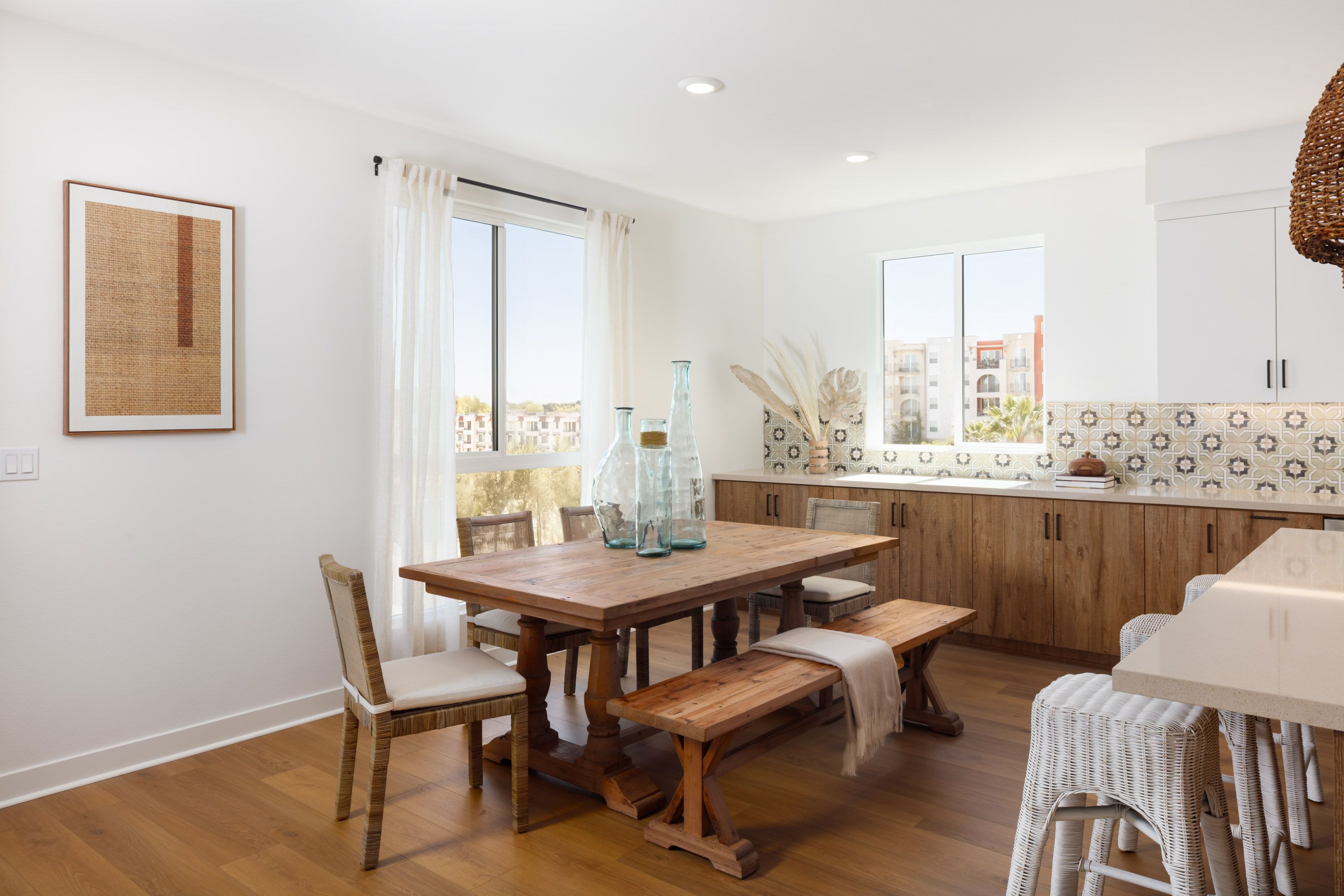 Model home dining area with plenty of light, located next to the kitchen