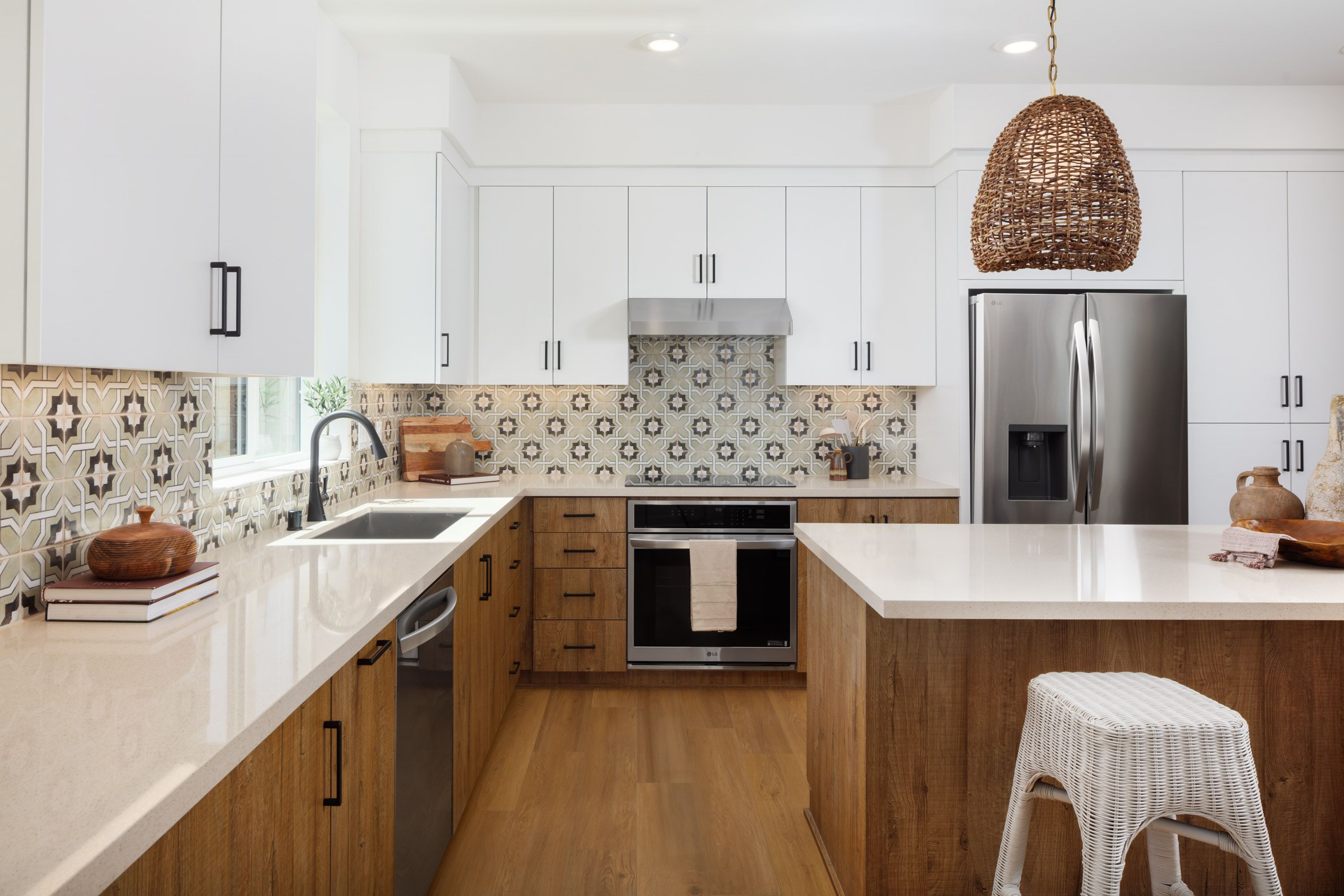 Model home kitchen with select stainless steel appliances and kitchen island