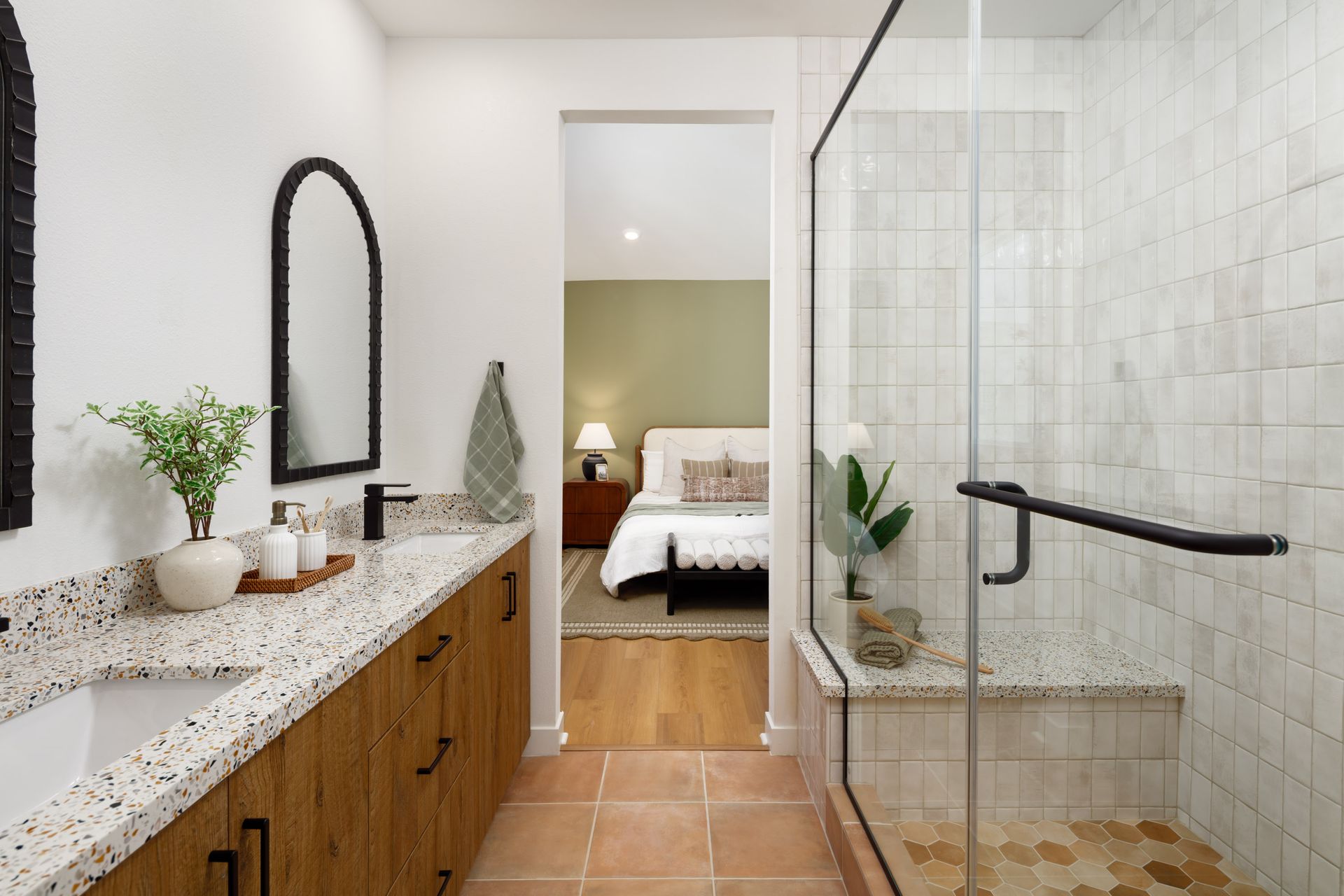 Model home primary bathroom with dual vanities and a separate shower