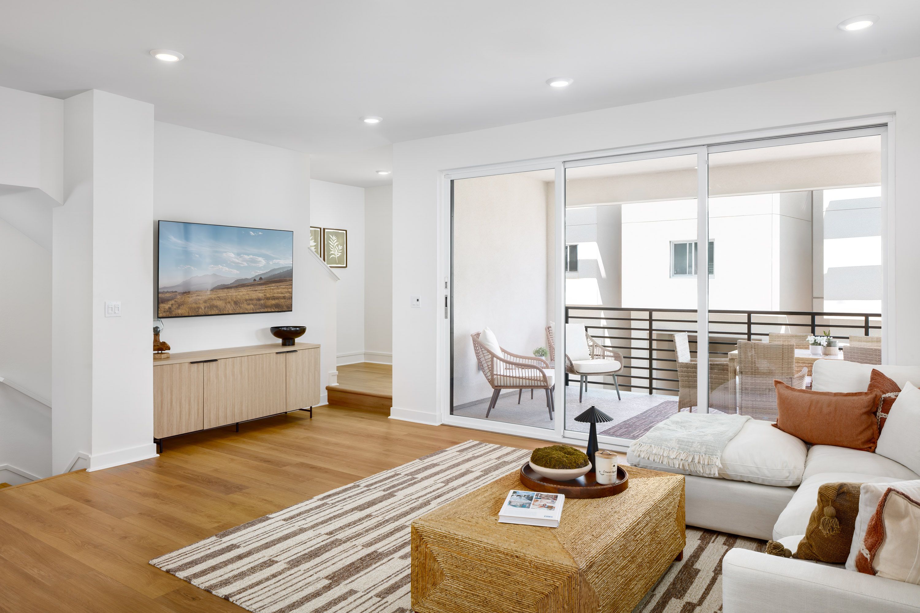 Model home bright living area adjacent to outdoor deck