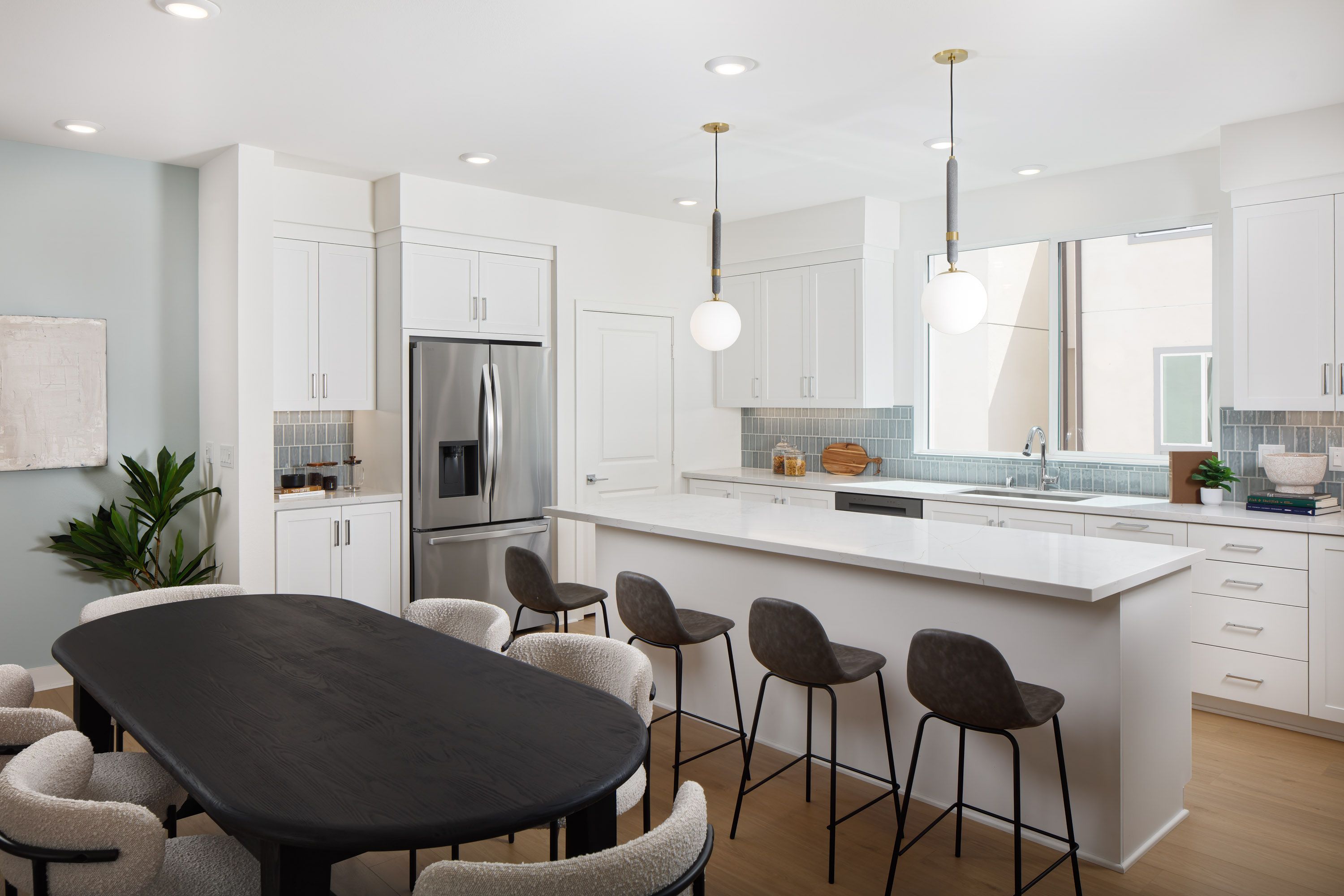 Model home open and connected dining and kitchen area